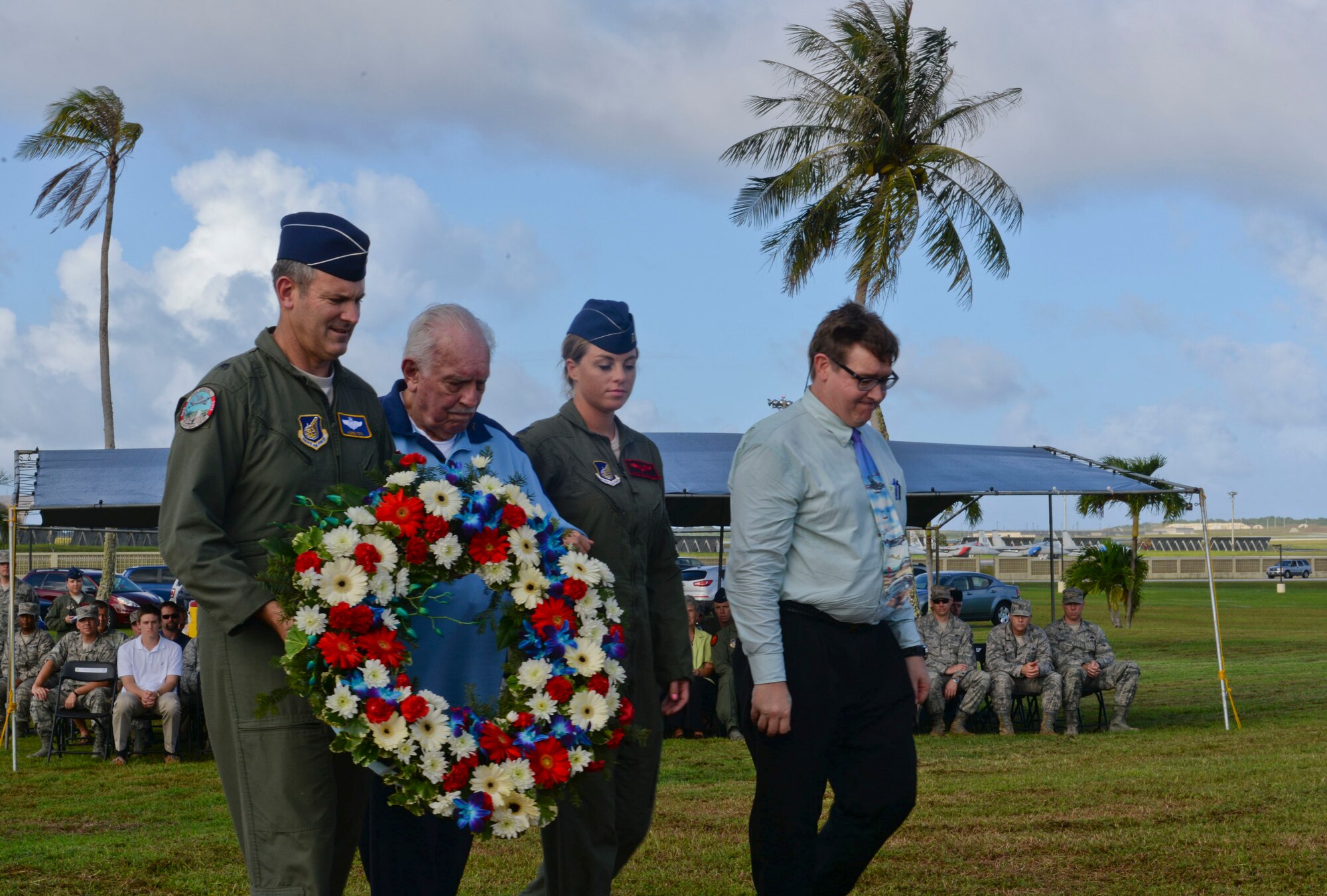 Brig. Gen. Andrew Toth, 36th Wing commander and Lt. Col. (ret.) Chuck McManus along with other Team Andersen members lays the ceremonial wreath during the Operation Linebacker II Remembrance Ceremony Dec. 18, 2014, at Andersen Air Force Base, Guam. McManus was a B-52 pilot stationed at Andersen during the operation. (U.S. Air Force photo by Staff Sgt. Robert Hicks/Released)  