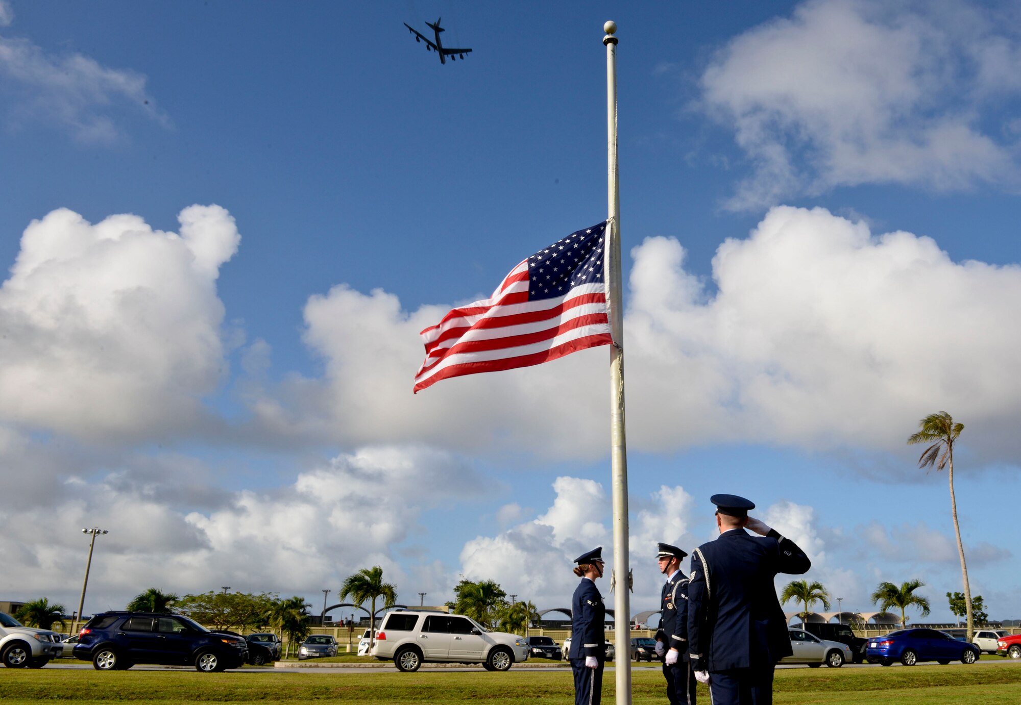 The Andersen Air Force Base Honor Guard lowers the flag to half-staff during the Operation Linebacker II Remembrance Ceremony Dec. 18, 2014, at Andersen AFB, Guam. The ceremony commemorated the 75 Airmen that lost their lives during the operation including 33 who were lost from 15 downed B-52 Stratofortress bombers. (U.S. Air Force photo by Staff Sgt. Robert Hicks/Released)  