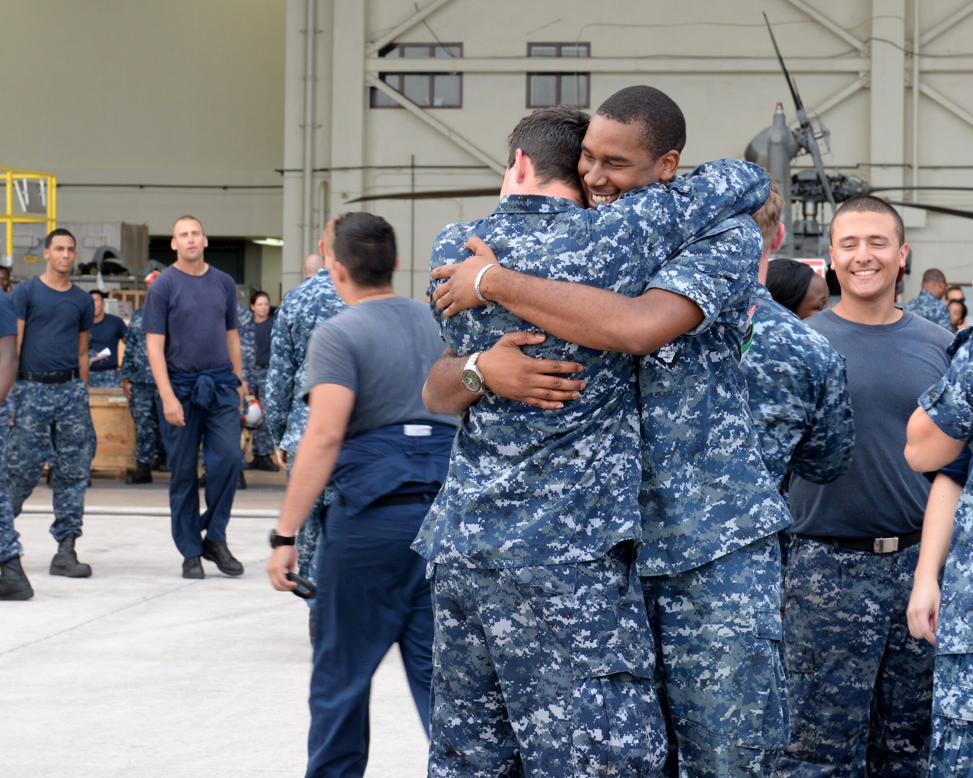 Families, friends and loved ones welcome home sailors from the Helicopter Sea Combat Squadron 25’s Detachment 1 after a seven month deployment Dec. 11, 2014, at Andersen Air Force Base, Guam. Detachment 6 returned after a six month deployment in the Pacific theater. (U.S. Air Force photo by Airman 1st Class Amanda Morris/Released)