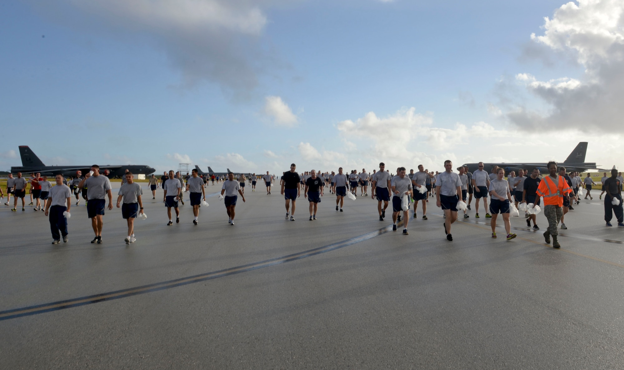 Members of Team Andersen participate in a holiday fun-run and foreign object damage walk Dec 18, 2014, at Andersen Air Force Base, Guam. The wing run was approximately 3.5 miles and was followed by a FOD walk on the flightline. The event was designed to promote esprit de corps, promote physical fitness and ensure that the flightline was clear of any objects that could potentially damage aircraft. (U.S. Air Force photo by Staff Sgt. Robert Hicks/Released)