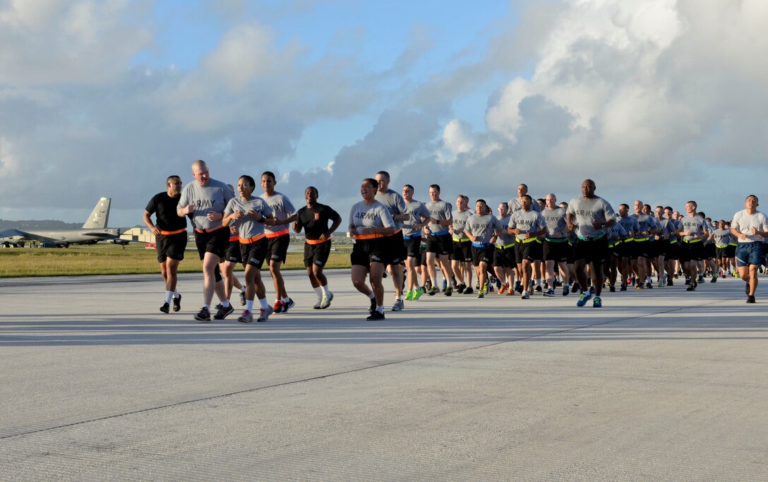 Members of Team Andersen participate in a holiday fun-run and foreign object damage walk Dec 18, 2014, at Andersen Air Force Base, Guam. The wing run was approximately 3.5 miles and was followed by a FOD walk on the flightline. The event was designed to promote esprit de corps, promote physical fitness and ensure that the flightline was clear of any objects that could potentially damage aircraft. (U.S. Air Force photo by Staff Sgt. Robert Hicks/Released)