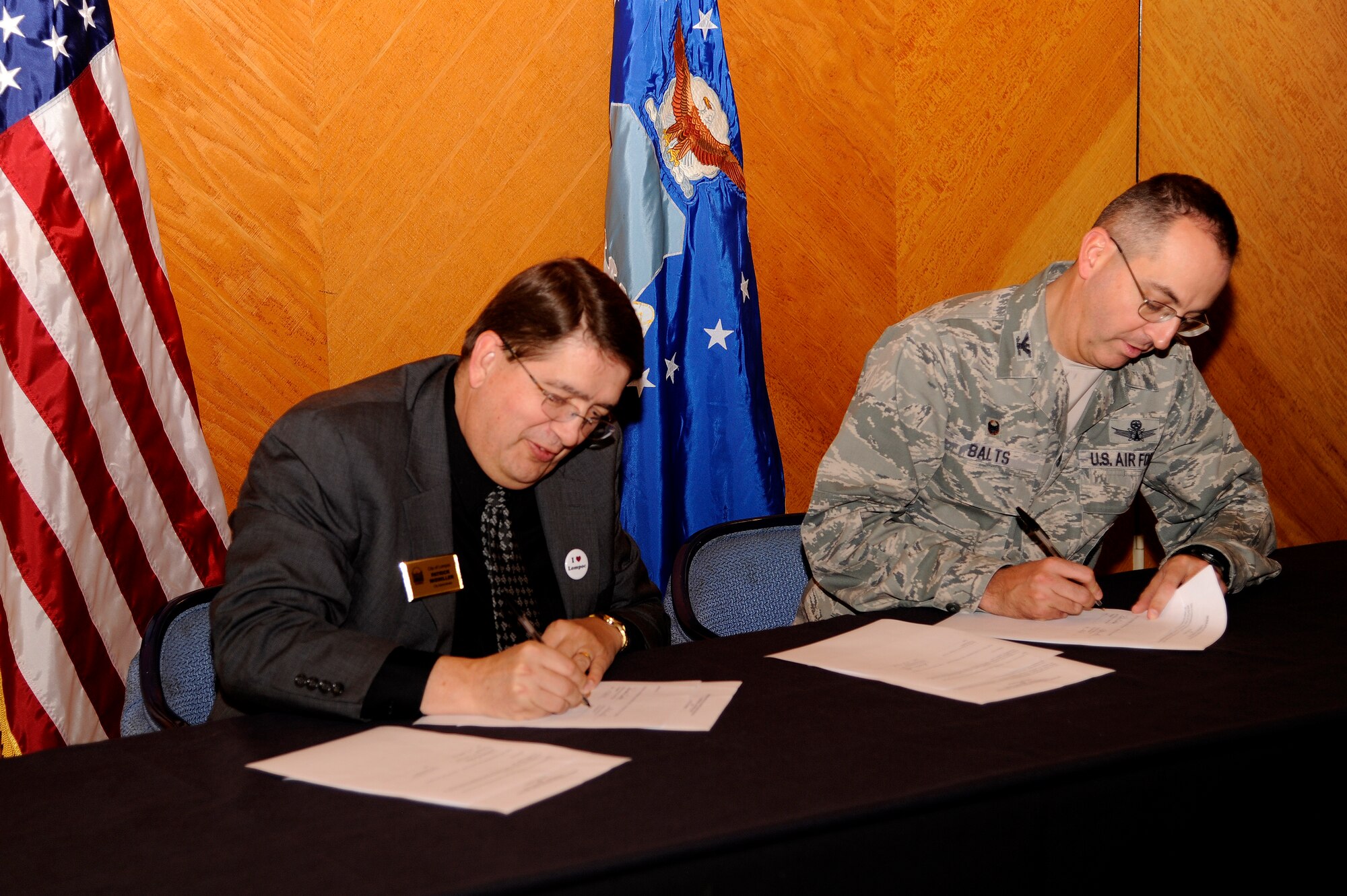 Col. Keith Balts, 30th Space Wing commander, and Patrick Wiemiller, Lompoc city administrator, sign a memorandum of understanding at Marshallia Ranch Golf Course, Dec. 17, 2014, Vandenberg Air Force Base, Calif. The signing of the MOU is to create an agreement between the City of Lompoc’s recreation division and U.S. Air Force representatives for golf course discounts and aquatic services. (U.S. Air Force photo by Staff Sgt. Jim Araos/Released)