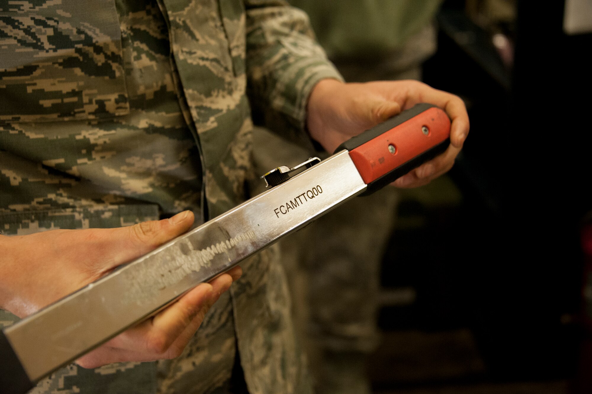 The new laser etcher is demonstrated to members of the 92nd Contracting Squadron Dec. 5, 2014, at Fairchild Air Force Base, Wash. The laser etcher was showcased during a tour allowing 92nd CONS member to see the new equipment they assisted the maintainers in purchasing.  The laser etcher was recently installed in the 92 AMXS sortie support section and is able to conduct extremely precise etching on tools and other products.  Its capabilities standardize the way tools are labeled, saving manpower and resources. (U.S. Air Force photo/Airman 1st Class Nicolo J. Daniello)