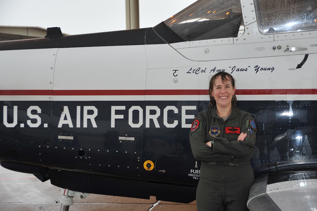 Lt. Col. Amy Young, 80th Flying Wing T-6 Texan II instructor, stands next to her plane after completing her “fini-flight” on Dec. 18, 2014 at Sheppard Air Force Base, Texas. Fini-flights are a long-standing military aviator tradition honoring a pilot on their departure from an assignment or their retirement from the Air Force. (U.S. Air Force photo/Airman 1st Class Robert L. McIlrath)