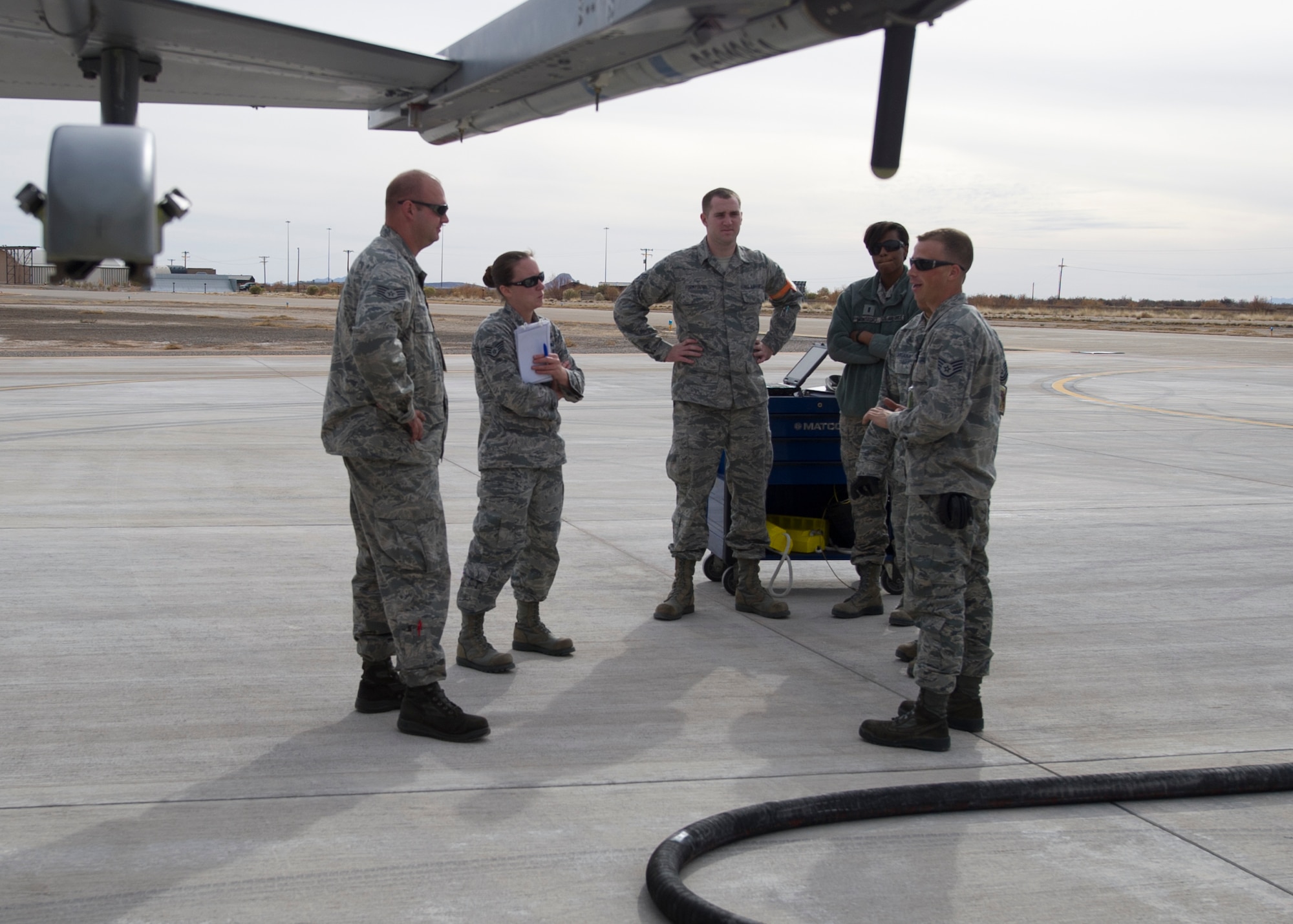 Instructors discuss training material with students at the end of training for the F-16 Fighting Falcon at Holloman Air Force Base, N.M., Dec. 16. Students participate in Holloman’s first F-16 Fighting Falcon Hot Refueling course. The course has two phases, academic and practical training. The course is intended to reduce the time spent on aircraft maintenance, ensuring the aircraft gets back to the mission faster. (U.S. Air Force photo by Senior Airman Leah Ferrante/released)