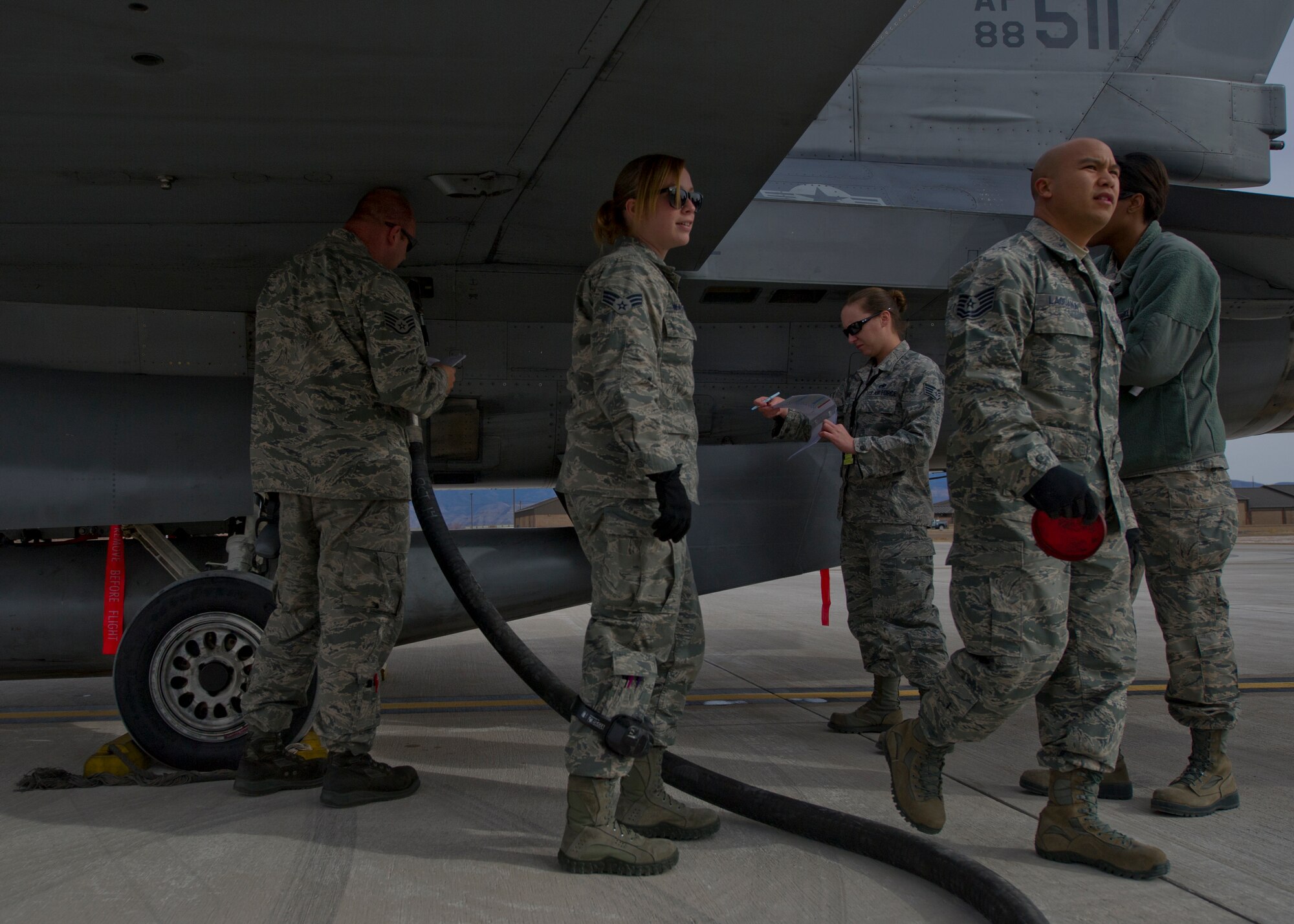 Members from the 49th Logistics Readiness Squadron and the 54th Fighter Group join together to train personnel on Holloman’s first F-16 Fighting Falcon Hot Refueling course at Holloman Air Force Base, N.M., Dec. 16. During the training, students learn the technical order, warnings, cautions and different positions involved in the refueling. “It’s beneficial for us to perform this type of operation because this is something we perform on deployments. While deployed, hot refueling becomes a regularly-occurring operation. So having the opportunity to work with the 54th and do it here keeps our guys more proficient in operations,” said Master Sgt. Raymond Lara, 49th Logistics Readiness Squadron section flight chief fuels information service center. (U.S. Air Force photo by Senior Airman Leah Ferrante/released)