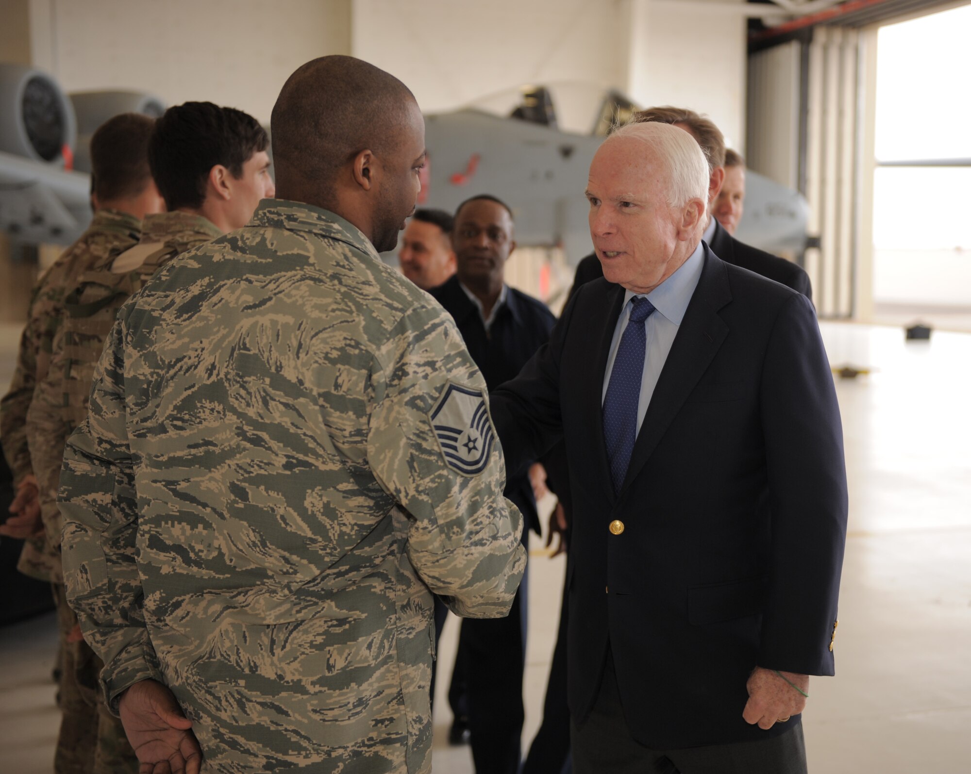 U.S. Air Force Master Sgt. Marcquis Simon, 48th Rescue Squadron logistics flight superintendent, shakes hands with Sen. John McCain at Davis-Monthan Air Force Base, Ariz., Dec. 18, 2014. Sens. McCain and Jeff Flake, as well as Rep. Paul Gosar of Arizona, were visiting several military installations across Arizona throughout the day.  (U.S. Air Force photo by Airman 1st Class Chris Drzazgowski)