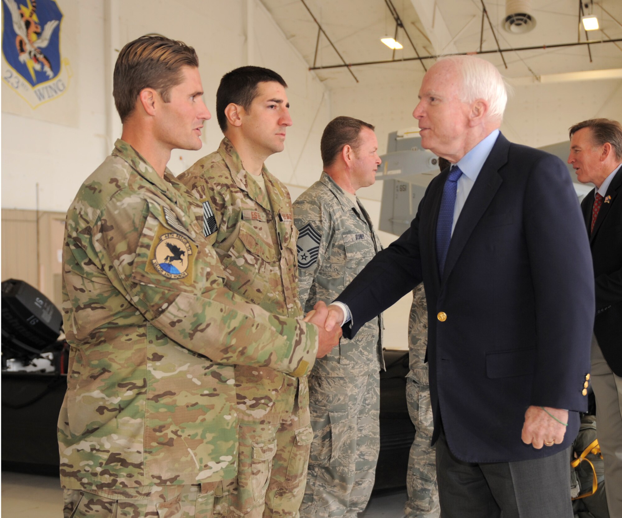 U.S. Air Force Staff Sgt. Lorin Schlecht, 48th Rescue Squadron survival, evasion, resistance and escape specialist, shakes hands with Sen. John McCain at Davis-Monthan Air Force Base, Ariz., Dec. 18, 2014. Sens. McCain and Jeff Flake, as well as Rep. Paul Gosar of Arizona, were visiting several military installations across Arizona, throughout the day.  (U.S. Air Force photo by Airman 1st Class Chris Drzazgowski)