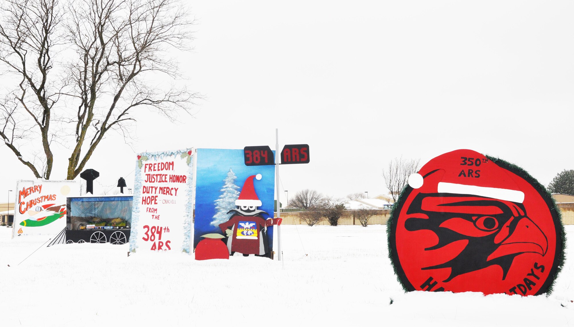 The base holiday cards lining the main road are dusted with snow after a storm hit the base Dec. 17, McConnell Air Force Base, Kan., Dec. 18, 2014.  The storm resulted in more than 2 inches of snow.  (U.S. Air Force photo by Tech. Sgt. Abigail Klein)