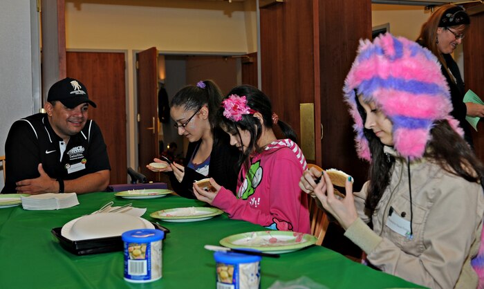 Members of Team Beale decorate cookies during the Exceptional Family Member Program holiday party Dec. 17, 2014, at Beale Air Force Base, Calif. The EFMP is designed to provide support to family members, both adult and children with special needs such as a physical, developmental, or mental disorder requiring specialized services. (U.S Air Force photo by Airman 1st Class Ramon A. Adelan/Released)