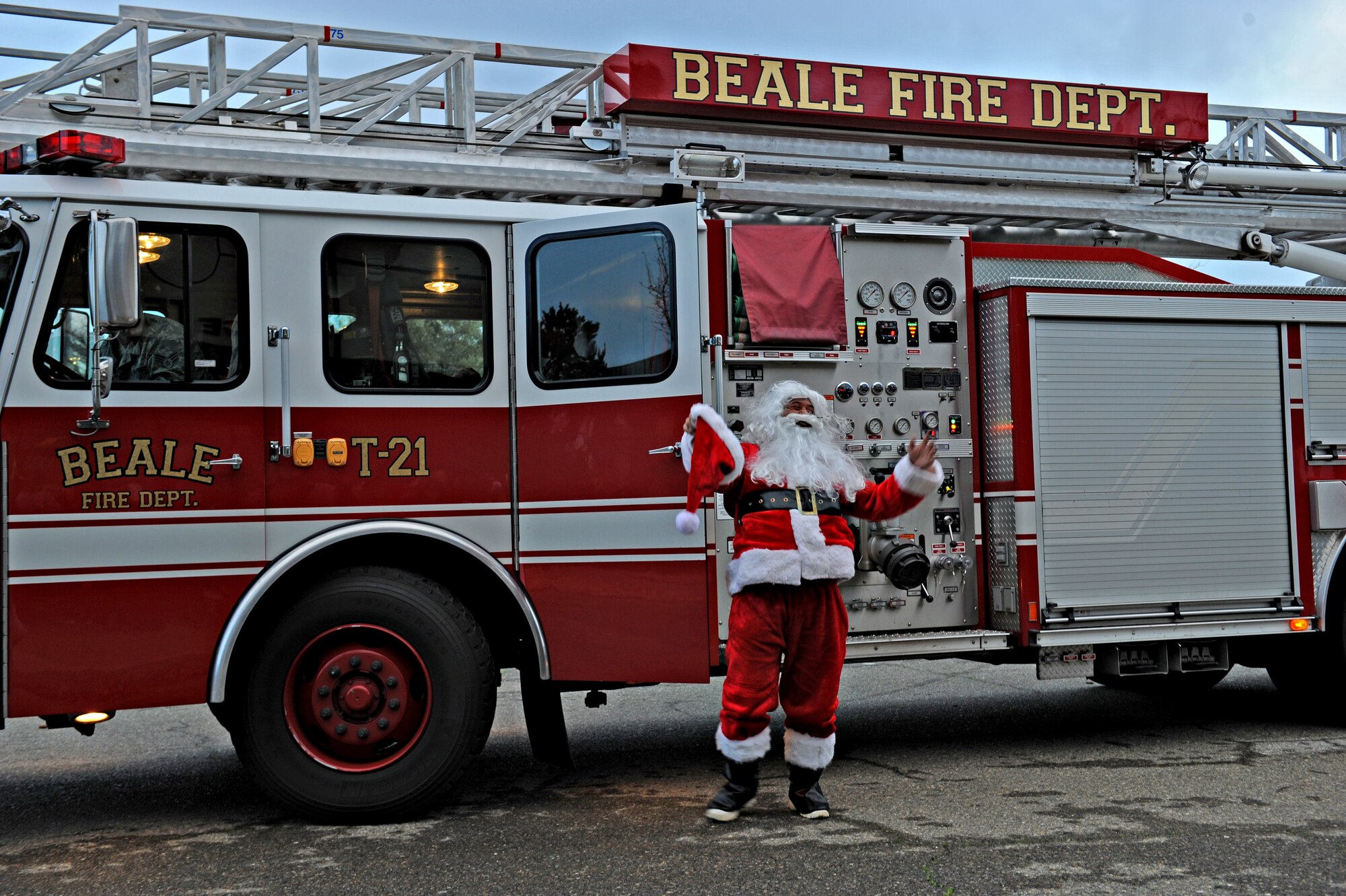 Santa Claus arrives at the Exceptional Family Member Program holiday party on a fire engine Dec. 17, 2014, at Beale Air Force Base, Calif. The EFMP is designed to provide support to family members, both adult and children with special needs such as a physical, developmental, or mental disorder requiring specialized services. (U.S Air Force photo by Airman 1st Class Ramon A. Adelan/Released)