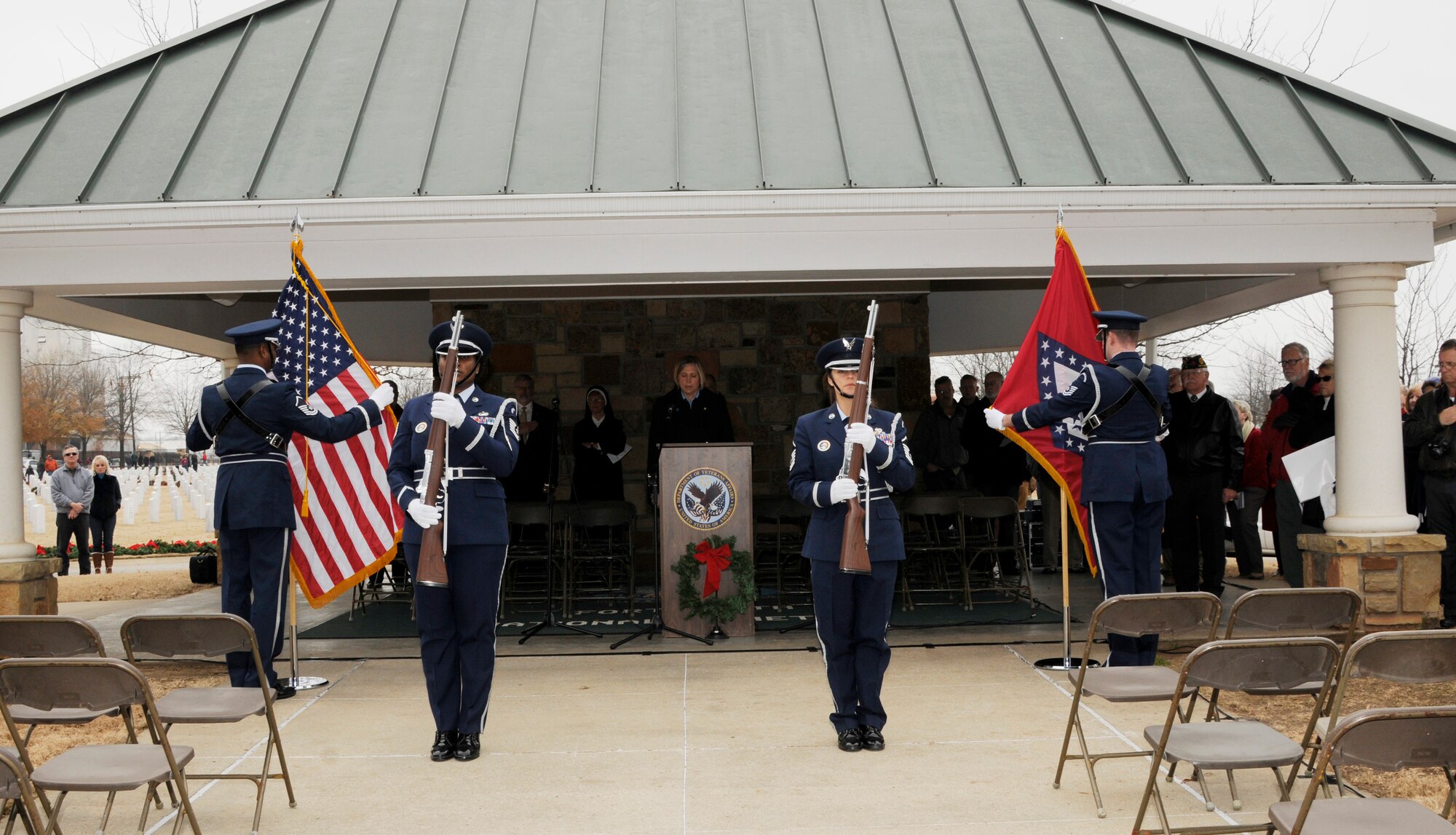 Airmen from the 188th Wing Honor Guard post the colors during the annual Christmas Honors wreath ceremony at the U.S. National Cemetery in Fort Smith, Ark., Dec. 13, 2014. In 2009, the Fort Smith Regional Chamber of Commerce held the first Christmas Honors inspired by the Wreaths Across America program. Wreaths Across America was founded by Morrill Worcester to remember the fallen, honor those who served and teach children the value of freedom. (U.S. Air National Guard photo by Staff Sgt. Hannah Dickerson/released)