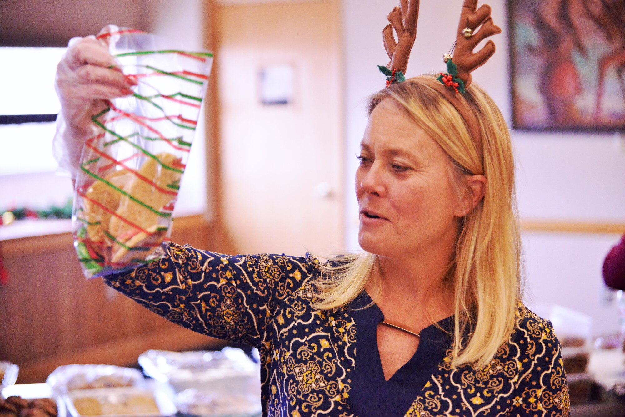 Kirtland Spouses' Club member Jane West prepares holiday cookies for distribution to Airmen in the dorms Dec. 16 at the Mountain View Club. (Photo by Todd Berenger)