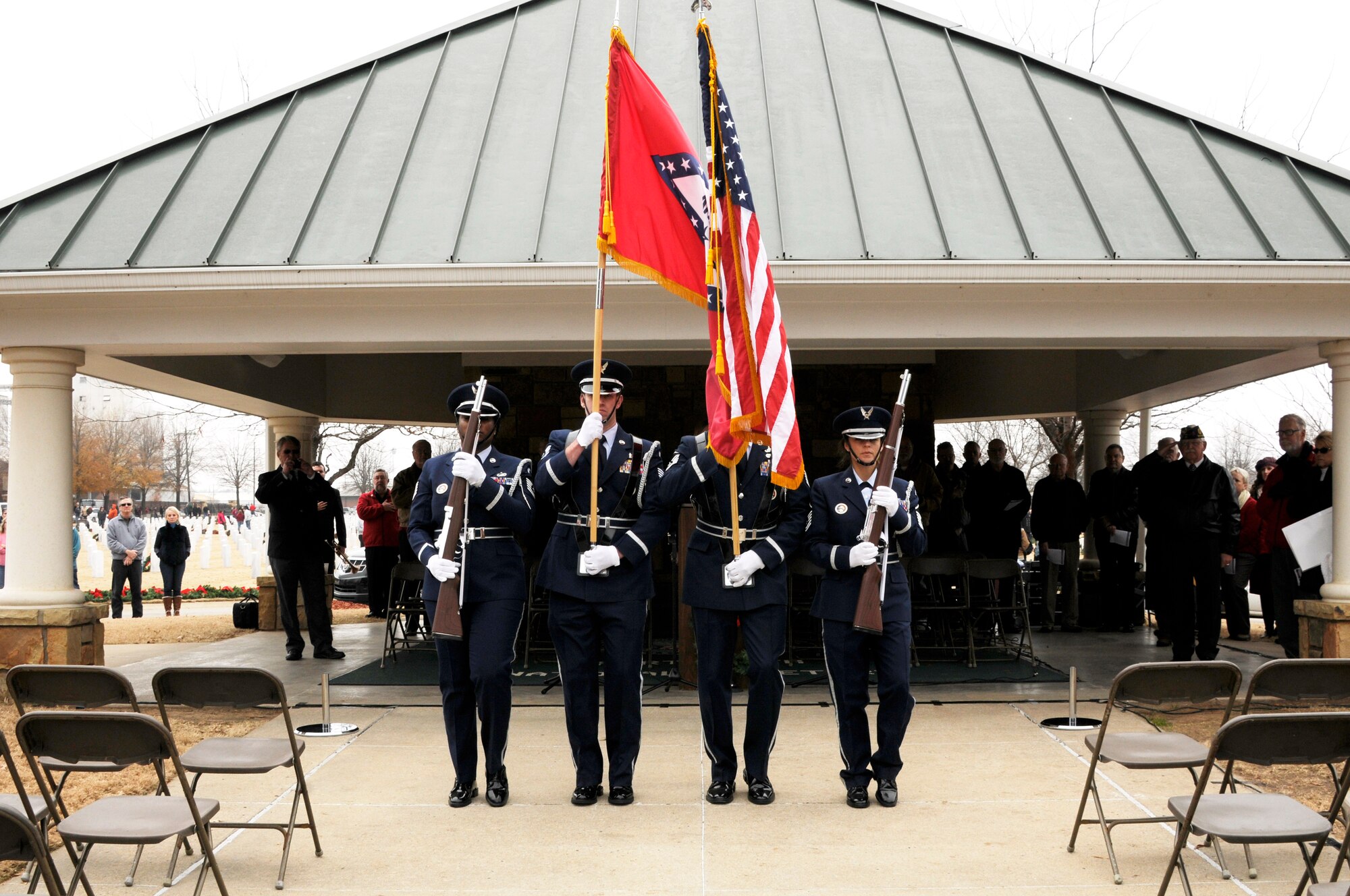 Airmen from the 188th Wing Honor Guard post the colors during the annual Christmas Honors wreath ceremony at the U.S. National Cemetery in Fort Smith, Ark., Dec. 13, 2014. In 2009, the Fort Smith Regional Chamber of Commerce held the first Christmas Honors inspired by the Wreaths Across America program. Wreaths Across America was founded by Morrill Worcester to remember the fallen, honor those who served and teach children the value of freedom. (U.S. Air National Guard photo by Staff Sgt. Hannah Dickerson/released)
