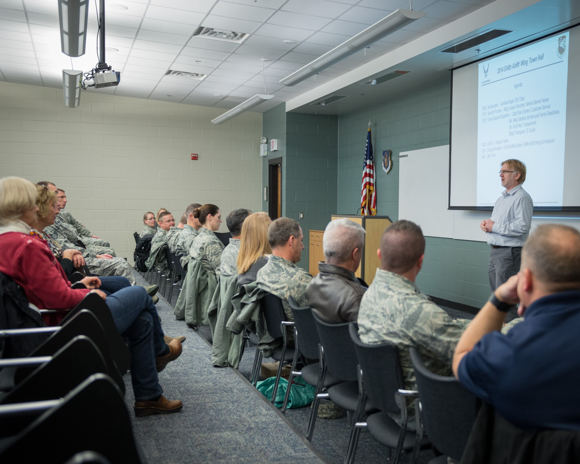 Mike Sanford, Airman and Family Readiness consultant, explains some of the services offered by his department during a townhall meeting held by the Integrated Delivery System (IDS).  The IDS is comprised of the many helping agencies at the Minneapolis-St. Paul Air Reserve Station, Minn., and held the biannual meeting during the December Unit Training Assembly weekend for all reservists, family members, retirees, civilians, and community members to address concerns and ask questions about quality of life matters at the 934th Airlift Wing. (U.S. Air Force photo by Shannon McKay/Released)