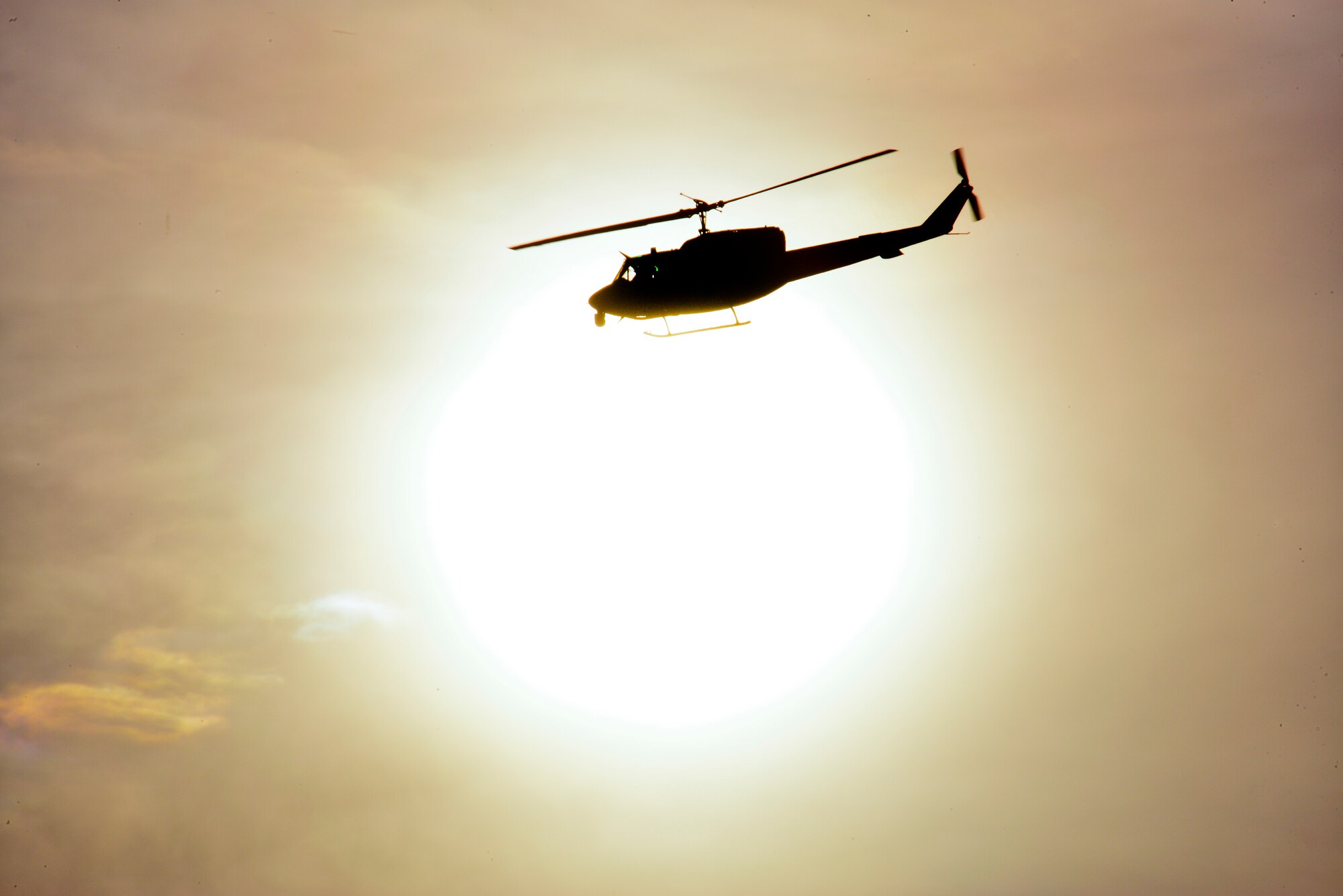 A UH-1N Helicopter flies over Minot Air Force Base, N.D., Dec. 11, 2014. The UH-1N is a light-lift utility helicopter used to support Air Force Global Strike Command missile wings and groups, Air Force District of Columbia, Air Force Survival School training, Air Advisory Operations, test and evaluation at Eglin AFB, Fla., and U.S. Pacific Command, as well as other agencies. (U.S. Air Force photo/Senior Airman Brittany Y. Bateman)