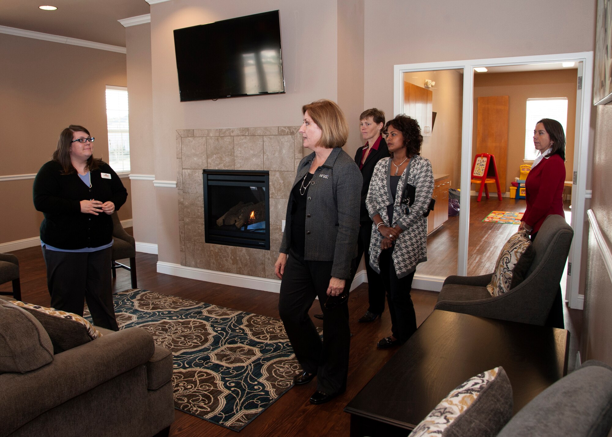 Mrs. Nancy Wilson, center, spouse of Lt. Gen. Stephen Wilson, commander of Air Force Global Strike Command, visits the Eastside Family Housing Community Center during a tour of Barksdale Air Force Base, La., Dec. 16, 2014. Wilson was joined by base leadership spouses to get a better understanding of life on base. (U.S. Air Force photo/Senior Airman Joseph A. Pagán Jr.) 