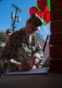 Col. Margret Jones, 628th Medical Group commander, signs in Dec. 12, 2014, at Joint Base Charleston, S.C. during a 628th Mental Health Open House. The open house event was designed to show commanders and first sergeants what mental health has to offer to Airmen. In addition to treating military related post-traumatic stress disorder, mental health has the capability to assist with a wide variety of life stressors through programs like Family Advocacy, Alcohol and Drug Abuse Prevention Program and Behavioral Health. (U.S. Air Force photo/Senior Airman Jared Trimarchi) 