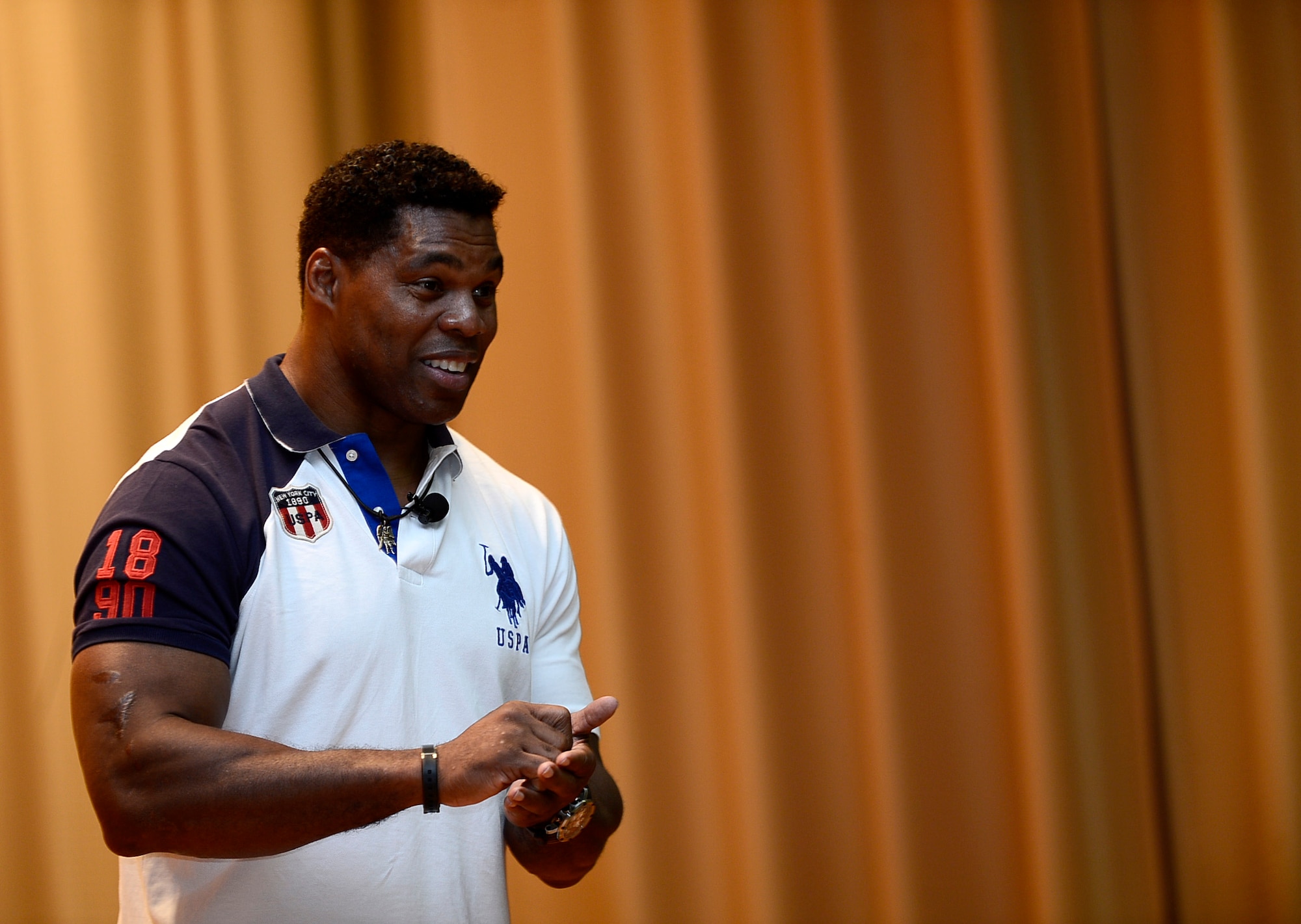 Herschel Walker, an all-star athlete and competitor, tells a story from his childhood at MacDill Air Force Base, Fla., Dec. 17, 2014. Walker shared his personal story to motivate others to achieve their best in the face of personal challenges. (U.S. Air Force photo by Airman 1st Class Tori Schultz/Released)