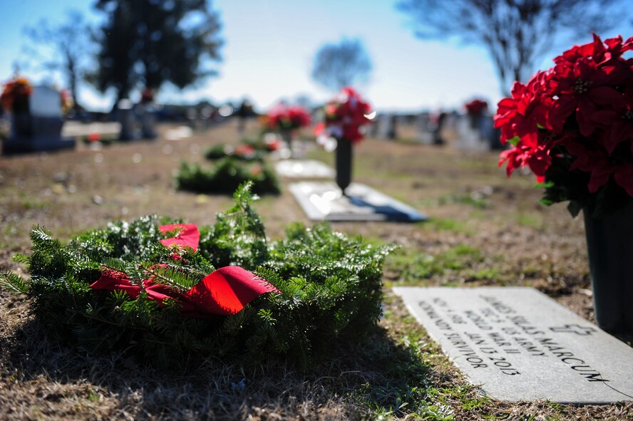 Wreaths lie on the graves of veterans during National Wreaths Across America Day at Evergreen Memorial Cemetery in Princeton, North Carolina, Dec. 13, 2014. During this second iteration of the event at Evergreen, approximately $4,500 was raised to fund the 450 wreaths that were laid during the ceremony. (U.S. Air Force photo by Airman 1st Class Brittain Crolley)