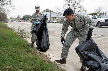 Staff Sgt. Carlos Ramos and Staff Sgt. Katie Bowling, both from the 902nd Security Forces Squadron, pick up trash along the exterior perimeter of Joint Base San Antonio-Randolph Dec. 11. Airmen and civilians from across JBSA-Randolph cleaned location’s FM 78 along JBSA-Randolph’s perimeter in support of Operation Clean Sweep. (U.S. Air Force photo by Johnny Saldivar)