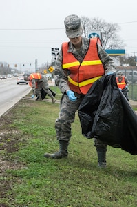 Second Lt. Noah Wood, 359th Medical Support Squadron Medical Information Flight commander, picks up trash along the exterior perimeter of Joint Base San Antonio-Randolph Dec. 11. Airmen and civilians from across JBSA-Randolph cleaned location’s FM 78 along JBSA-Randolph’s perimeter in support of Operation Clean Sweep. (U.S. Air Force photo by Johnny Saldivar)