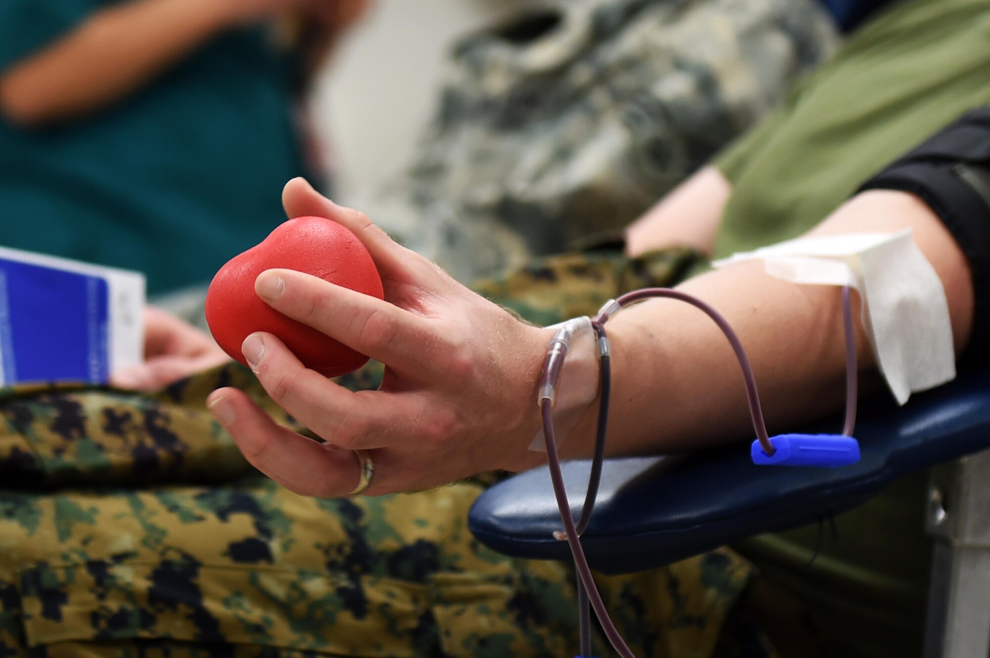 U.S. Marine Corps Sgt. Jeremy Johnson, Combat Logistics Battalion 453 administrator, donates blood during the Bonfils Blood Center blood drive Dec. 17, 2014, at the Buckley Health Promotions Program. Many Team Buckley members attended the blood drive to raise awareness for the need of blood donors. (U.S. Air Force photo by Airman 1st Class Emily E. Amyotte/Released)
