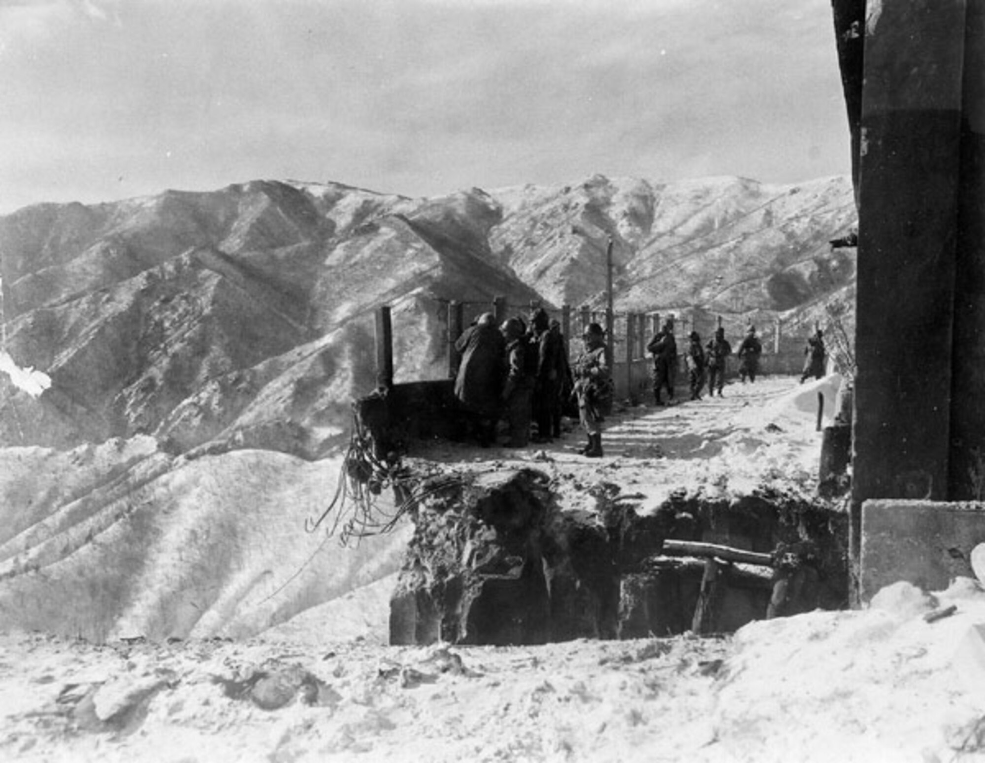 United Nation troops examine a road bridge at the Koto-ri hydroelectric plant in North Korea. The 24-foot section of the road bridge was destroyed by Chinese 9th Army troops in late November 1950, trapping 30,000 UN troops on the north side between Koto-ri and the Chosin Reservoir.  (Courtesy Photo)