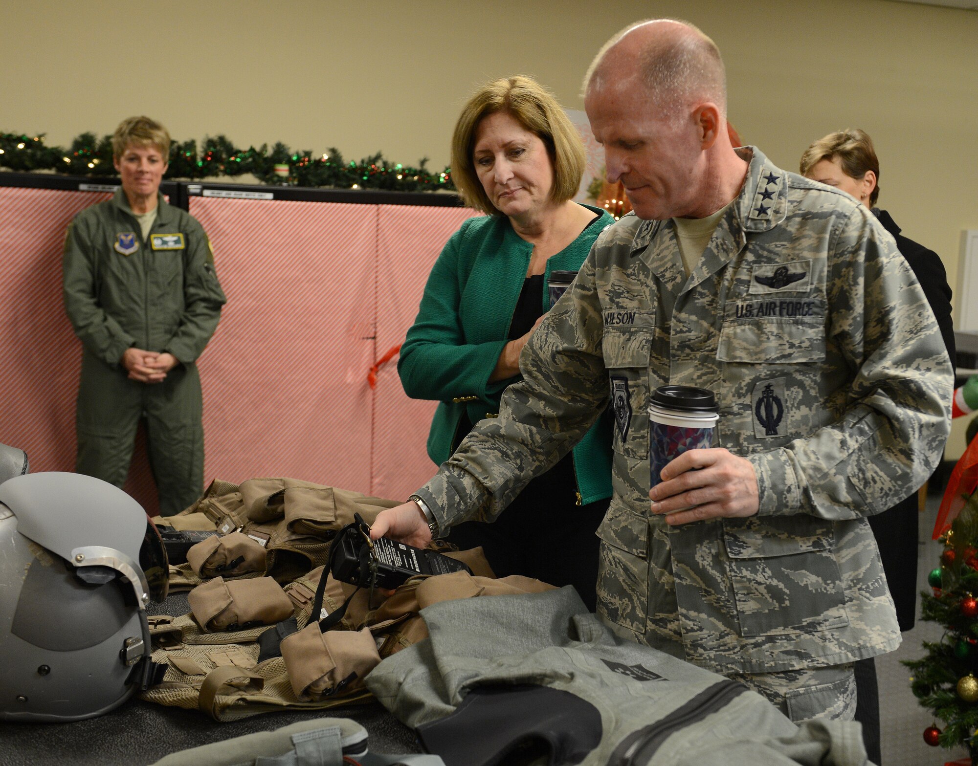 Lt. Gen. Stephen Wilson, commander of Air Force Global Strike Command, and his spouse Nancy, look at equipment aircrew members use during a visit to the 2nd Operations Support Squadron on Barksdale Air Force Base, La., Dec. 17, 2014. The Aircrew Flight Equipment section provides aircrew with the proper lifesaving equipment used in the event of a crash including helmets, oxygen masks, survival vests, anti-exposure suits, life preservers and night vision goggles. (U.S. Air Force photo/Senior Airman Benjamin Gonsier)