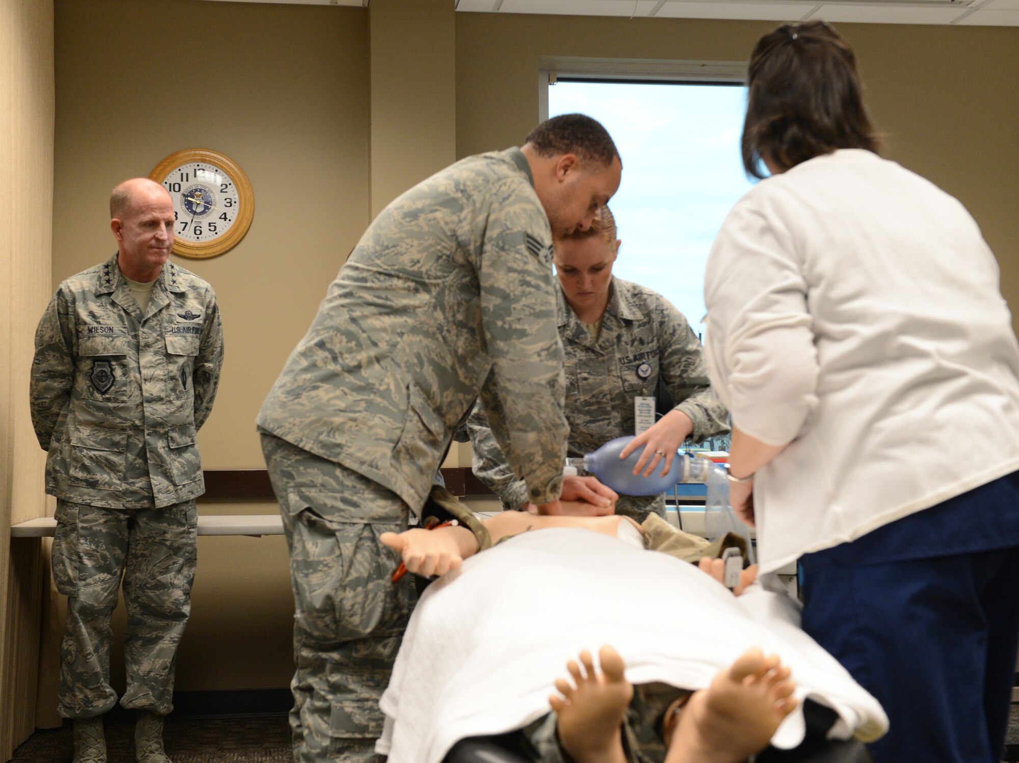 Airmen from the 2nd Medical Group provide Lt. Gen. Stephen Wilson, commander of Air Force Global Strike Command, a cardiopulmonary resuscitation demonstration during a visit to the 2nd Bomb Wing on Barksdale Air Force Base, La., Dec. 17., 2014.  For training purposes, the 2nd MDG uses dummies to simulate medical emergencies. (U.S. Air Force photo/Senior Airman Benjamin Gonsier)