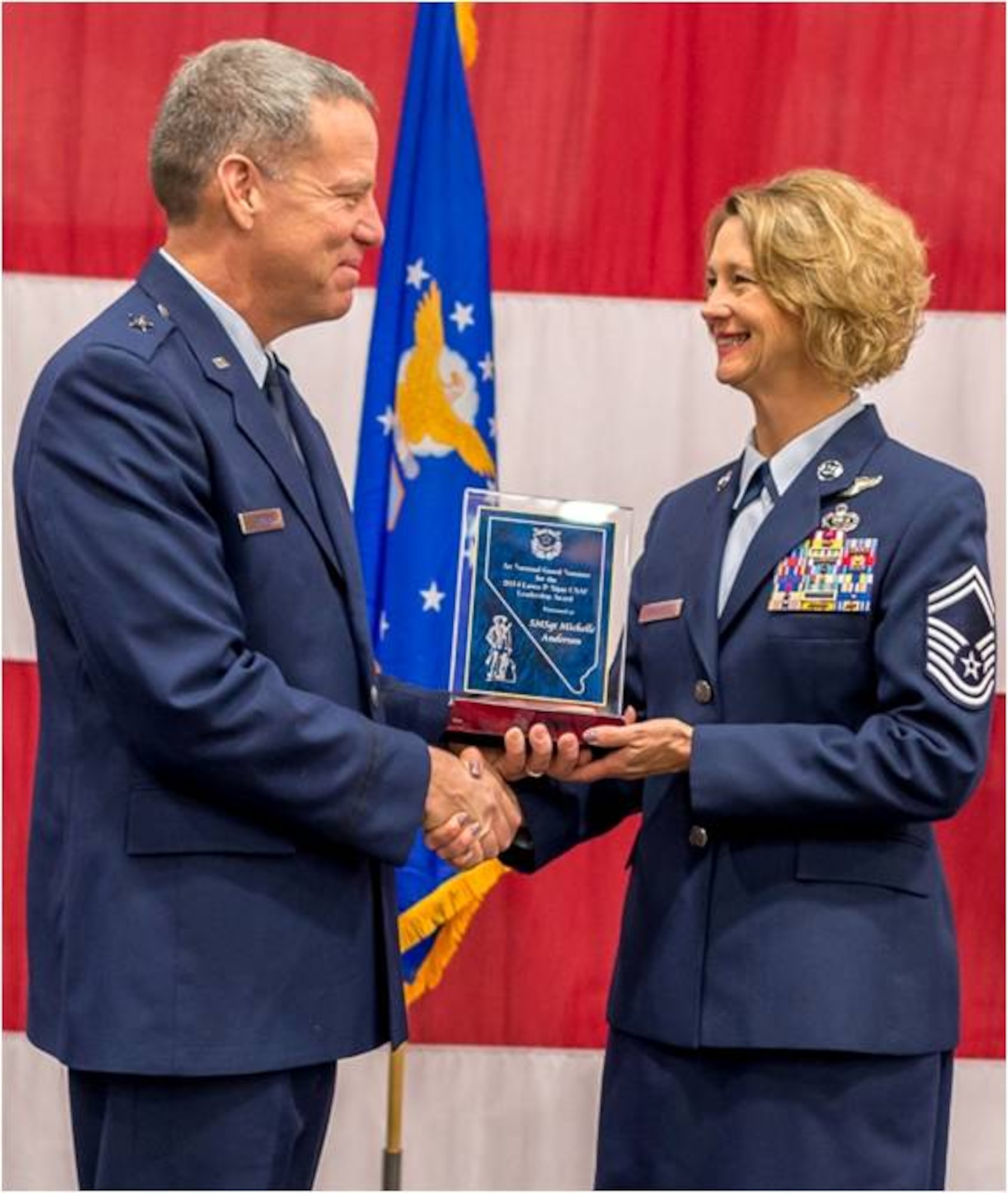 Senior Master Sgt. Michelle Anderson of the 152nd Intelligence Squadron accepts the United States Air Force’s Lance P. Sijan Leadership Award from Brig. Gen. David Snyder at the Nevada Air National Guard’s Annual Awards Ceremony on December 7, 2014.USAF photo by Maj. Kristoffer Pfalmer RELEASED.