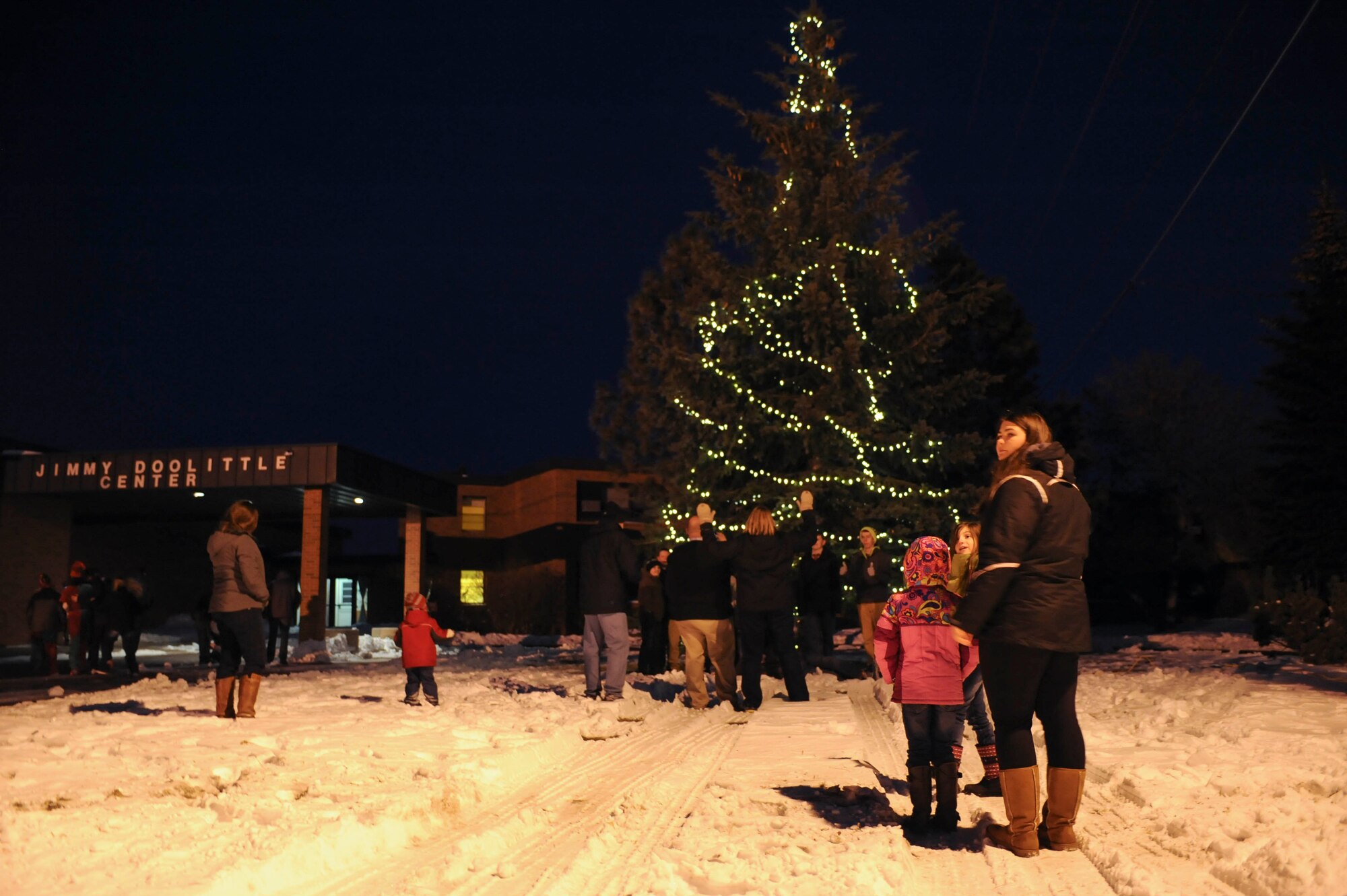 Lights illuminate a tree during the holiday tree lighting event hosted at the Jimmy Doolittle Center on Minot Air Force Base, N.D. Dec. 6, 2014. Approximately 60 Airmen and their families attended the event as well as local community leaders, Boy Scouts and Santa Claus. (U.S. Air Force photo/Senior Airman Stephanie Morris)