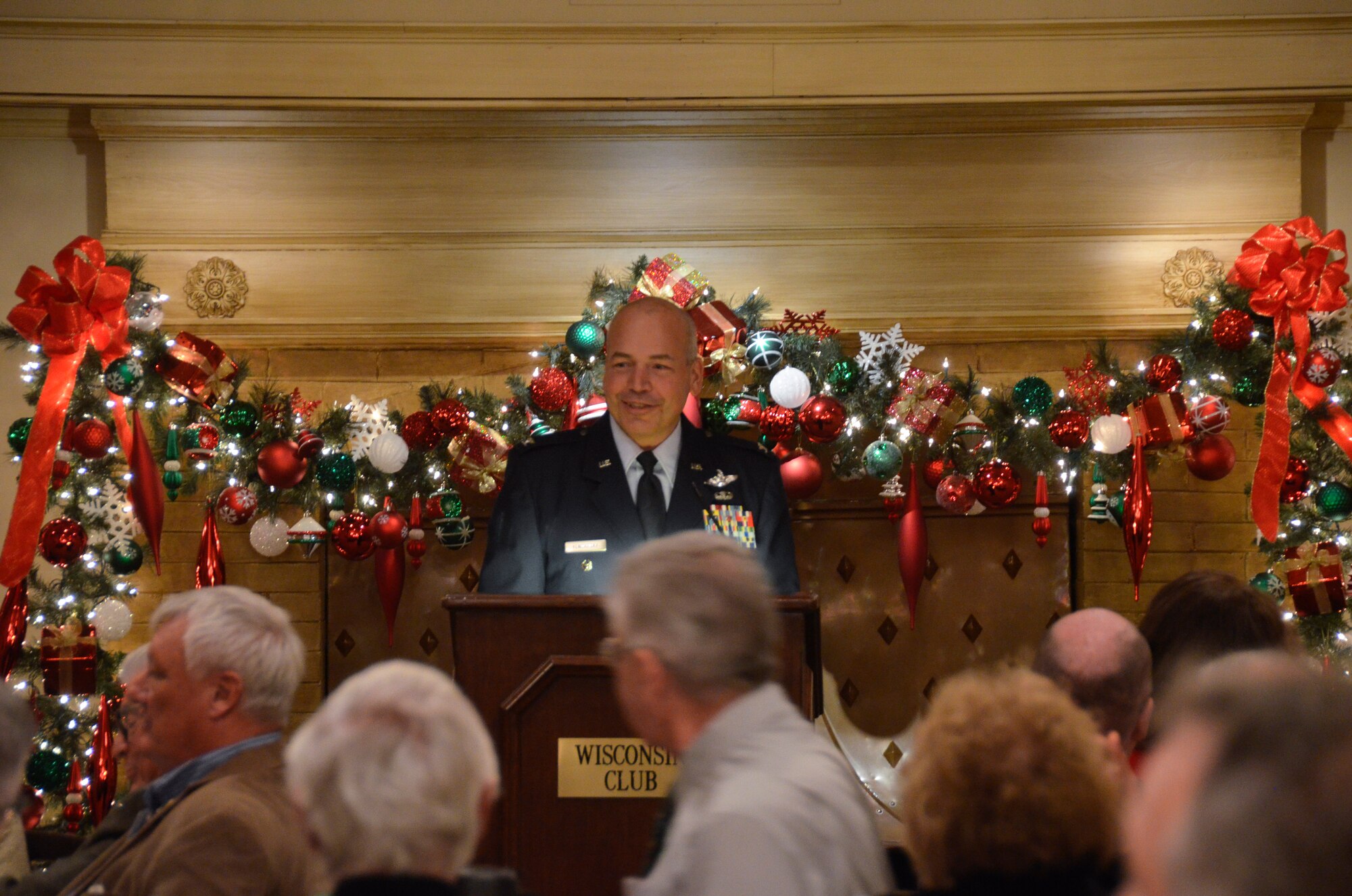 Col. Daniel S. Yenchesky, the wing commander of the 128th Air Refueling Wing delivers a speech at the 128th Community Council general membership meeting held at the Wisconsin Club, Milwaukee Friday, Dec. 12, 2014. Yenchesky’s presentation focused on his recent deployment and the 128 ARW’s missions and impact on the global scene. Yenchesky’s speech at the general membership meeting reminded the community members in attendance that the 128 ARW is still a vital part of the local community and the missions overseas. (U.S. Air National Guard photo by Maj. Sherri A. Hrovatin/Released)