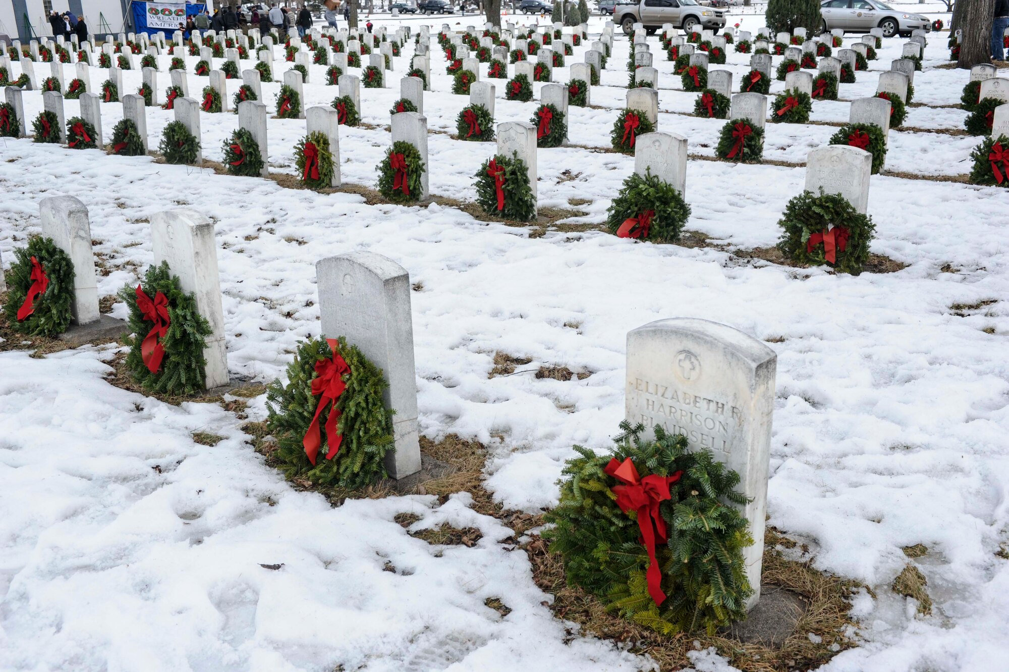Hundreds of wreaths rest against the headstones of veterans during a ceremony commemorating national Wreaths Across America Day at Rosehill Memorial Park Cemetery in Minot, N.D., Dec. 13, 2014. The ceremony occurred at the same time as hundreds of other ceremonies across the country to honor the service of veterans. (U.S. Air Force photo/Senior Airman Stephanie Morris)