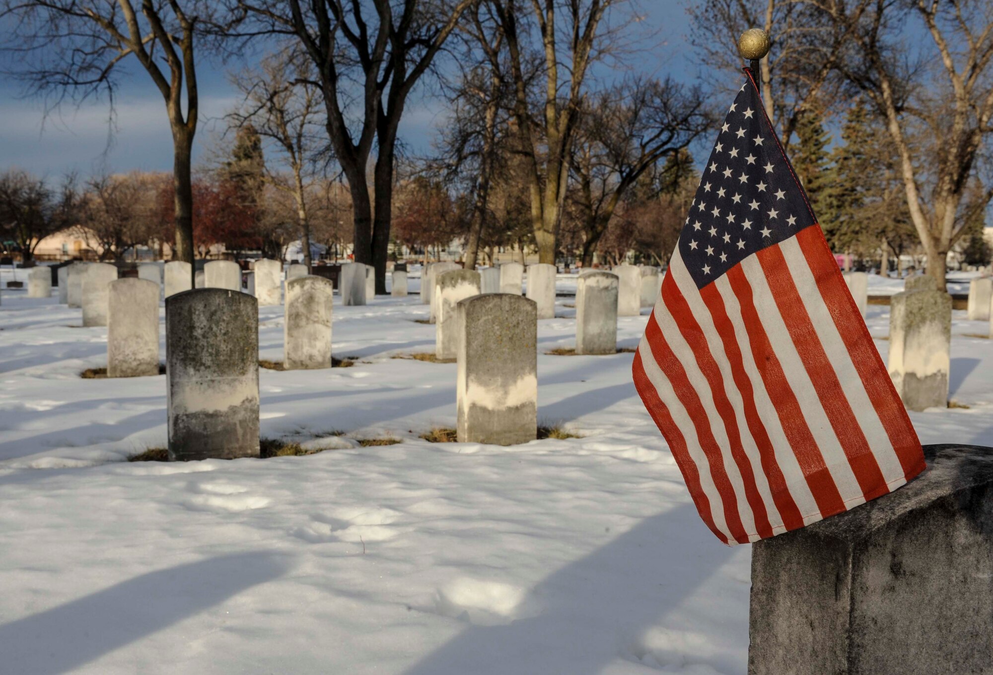 A flag is affixed the headstone of a veteran buried at Rosehill Memorial Park Cemetery in Minot, N.D., Dec. 13, 2014. The thirteenth marked national Wreaths Across America day, during which wreaths were placed on the graves of veterans at more than 1,000 locations all around the world. (U.S. Air Force photo/Senior Airman Stephanie Morris)