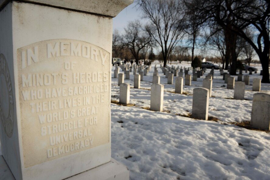 Snow-covered headstones sit near a monument dedicated to veterans buried at Rosehill Memorial Park Cemetery in Minot, N.D., Dec. 13, 2014. The thirteenth marked national Wreaths Across America Day, during which wreaths were placed on the graves of veterans at more than 1,000 locations all around the world. (U.S. Air Force photo/Senior Airman Stephanie Morris)