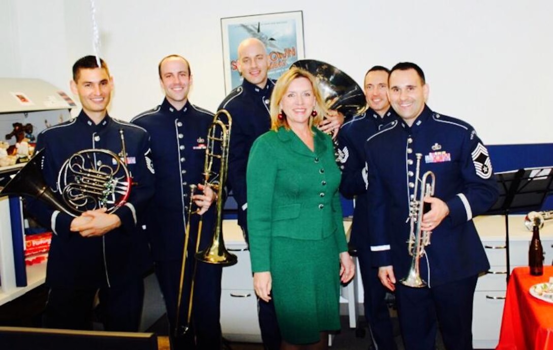 The Brass Quintet from the Ceremonial Brass performed for a holiday party and took a moment to pose with the Secretary of the Air Force Deborah Lee James. (US Air Force Photo/released)