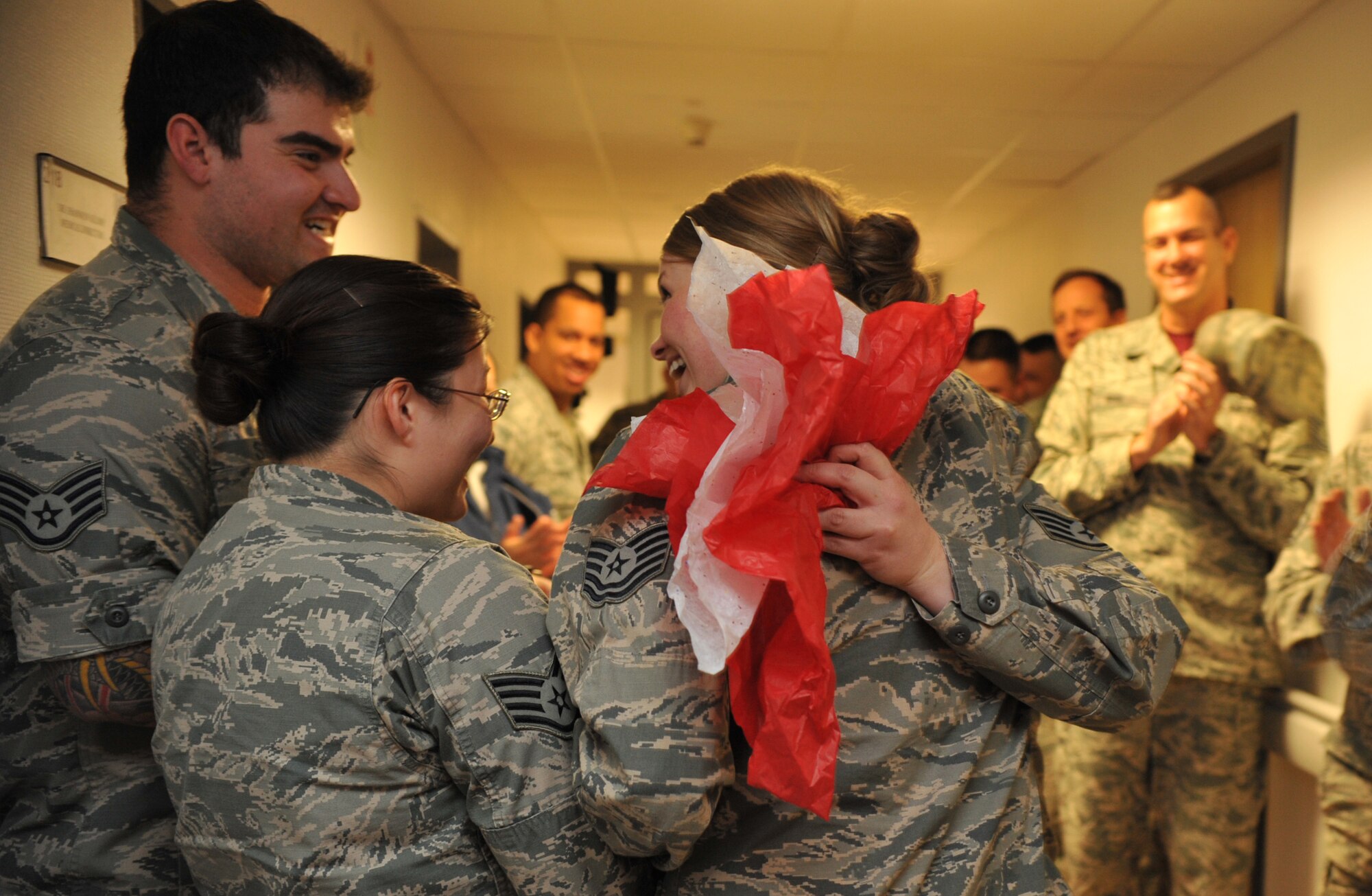 Friends of Staff Sgt. Lacy Owens, 86th Medical Group element b NCOIC, congratulate her on her STEP promotion to Tech. Sgt. at Ramstein Air Base, Germany, Dec. 12, 2014. The STEP program supplements existing Airmen promotion programs and is designed to accommodate unique circumstances that, in the commander’s judgment, clearly warrant promotion. It is intended to provide a means to promote Airmen for compelling, although perhaps not quantifiable reasons.
 (U.S. Air Force photo/Senior Airman Hailey Haux)

