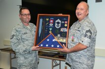 Tech. Sergeant Brian J. Becker and Chief Master Sergeant Charles K. Hoops, 132nd Fighter Wing, Iowa Air National Guard, Civil Engineering Squadron during retirement ceremony on 06 Dec 14 in the CE Building. 