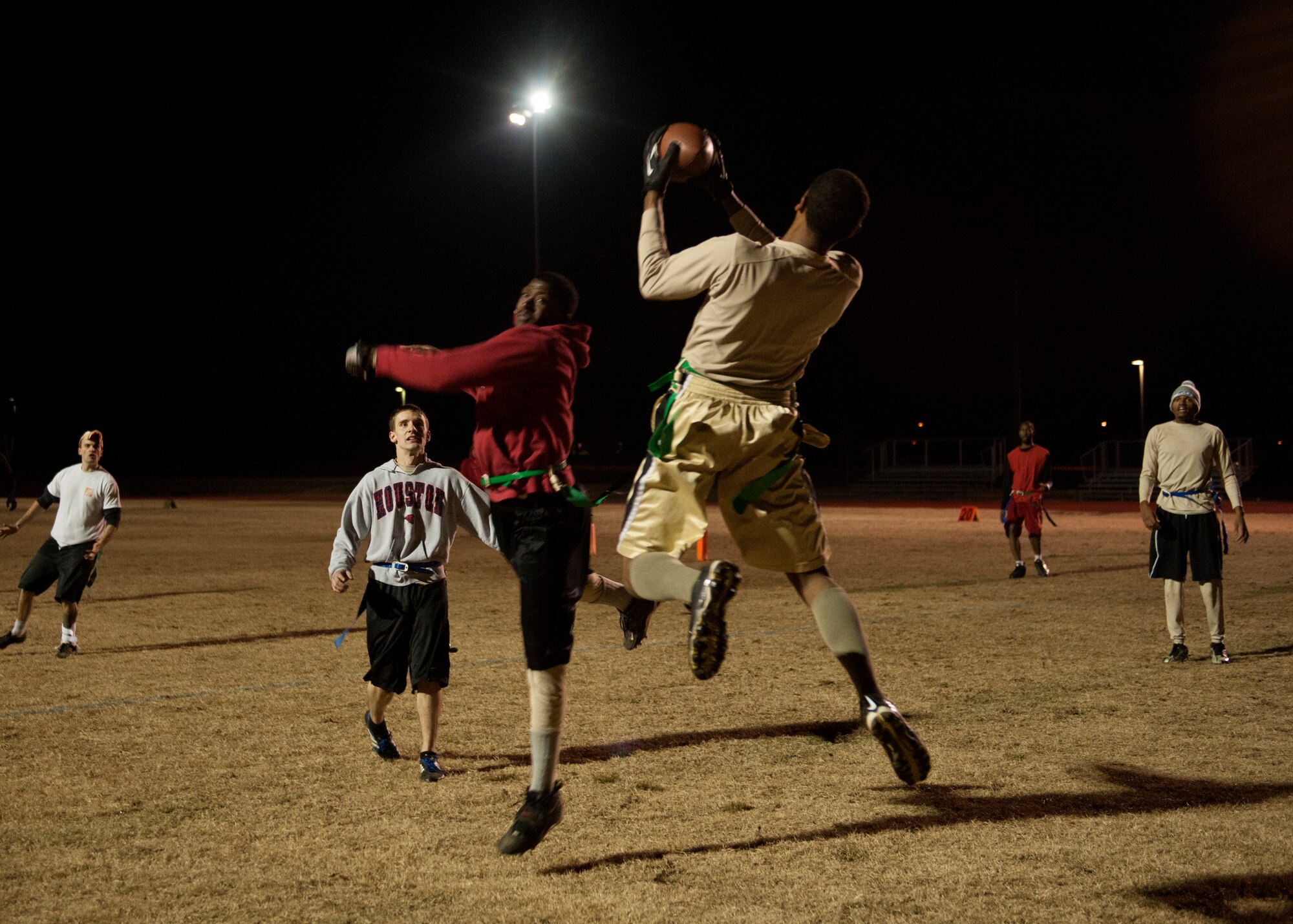 A receiver from the 19th Maintenance Squadron intramural football team #2 completes a touchdown pass Dec. 10, 2014, at Little Rock Air Force Base, Ark. The 19th MXS # 2 and #3 battled it out, team #2 won 27-21. (U.S. Air Force photo by Airman 1st Class Scott Poe)