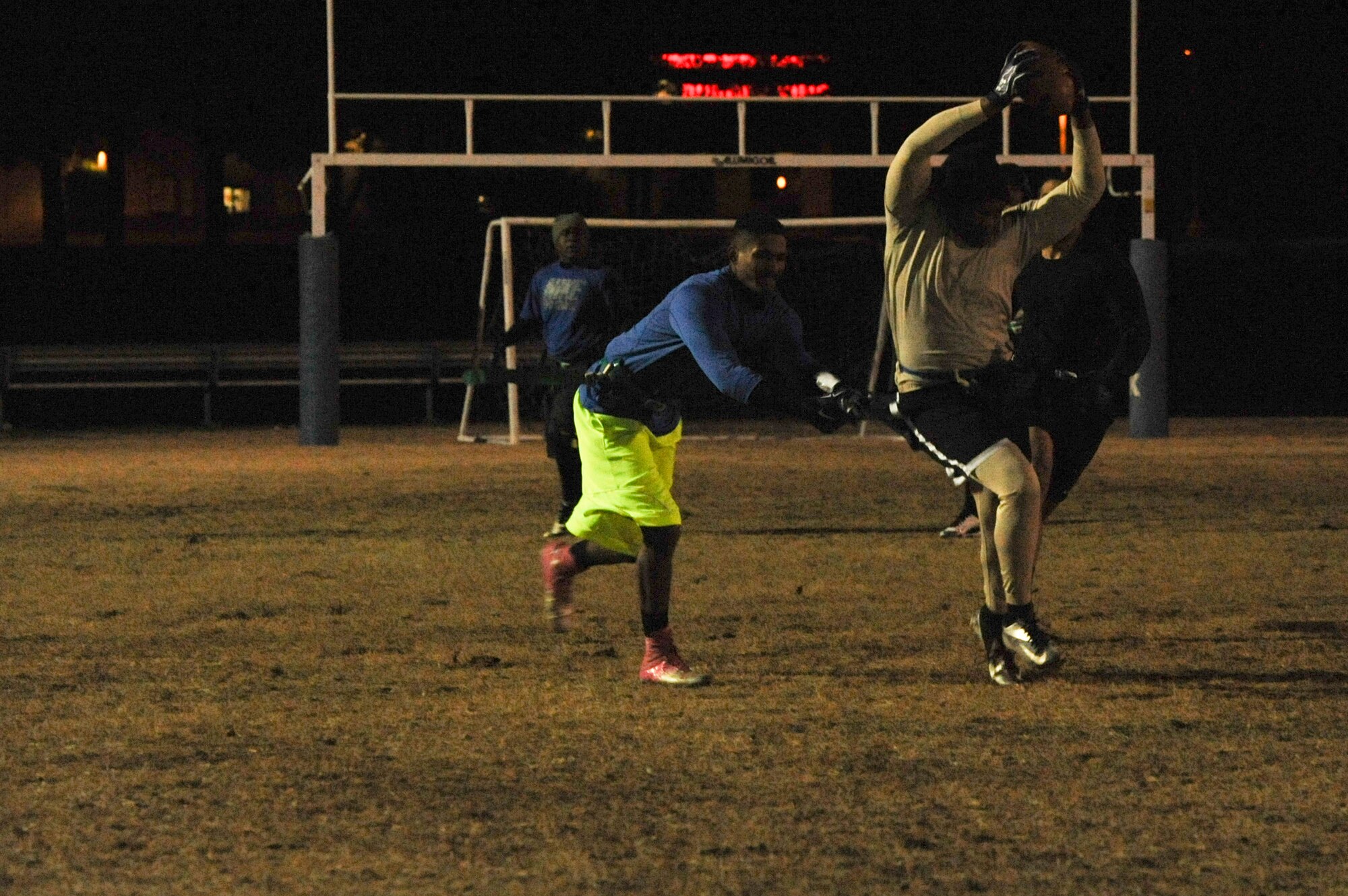 Airman 1st Class Trayvon Neil, a 19th Maintenance Squadron #3 player, dashes forward with the ball as his flag is pulled off Dec. 9, 2014, at Little Rock Air Force Base, Ark. The 19th MXS #3 played against the 314th Aircraft Maintenance Squadron and lost (U.S. Air Force photo by Airman 1st Class Mercedes Muro) 