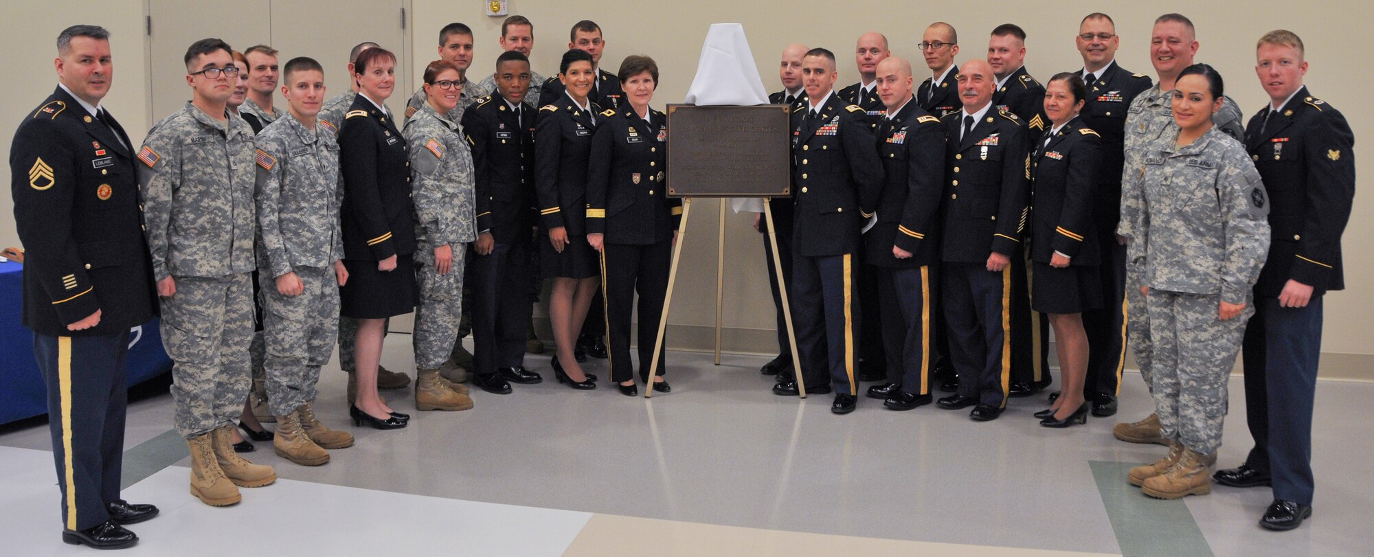 Maj. Gen. Margaret W. Boor, commanding general of the Army Reserve's 99th Regional Support Command, center, congratulates Soldiers of the Army Reserve's 399th Combat Support Hospital during the Dec. 13, 2014, grand opening and memorialization ceremony for the 1st Lt. Paul A. Doble Army Reserve Center in Portsmouth, New Hampshire. The new facility is named for Doble, who served with the Army's 180th Infantry Regiment during World War II and was killed in action in France Sept. 25, 1944, earning a Purple Heart and Silver Star. (U.S. Army photo by Staff Sgt. Shawn Morris/Released)