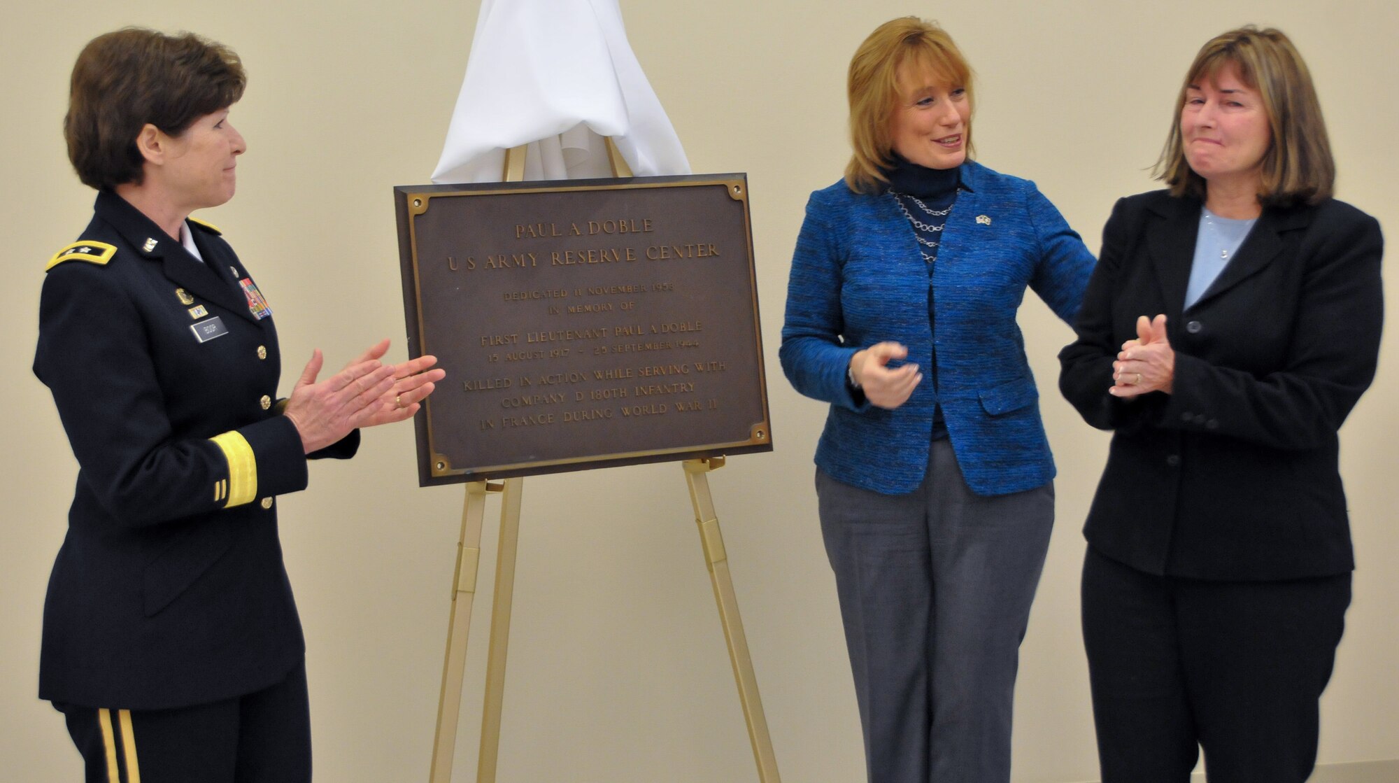 From left, Maj. Gen. Margaret W. Boor, commanding general of the Army Reserve's 99th Regional Support Command, New Hampshire Gov. Maggie Hassan and Kathleen Barry, niece of 1st Lt. Paul A. Doble, unveil the memorial plaque during the Dec. 13,2014, grand opening and memorialization ceremony for the 1st Lt. Paul A. Doble Army Reserve Center in Portsmouth, New Hampshire. The new facility is named for Doble, who served with the Army's 180th Infantry Regiment during World War II and was killed in action in France Sept. 25, 1944, earning a Purple Heart and Silver Star. (U.S. Army photo by Staff Sgt. Shawn Morris/Released)