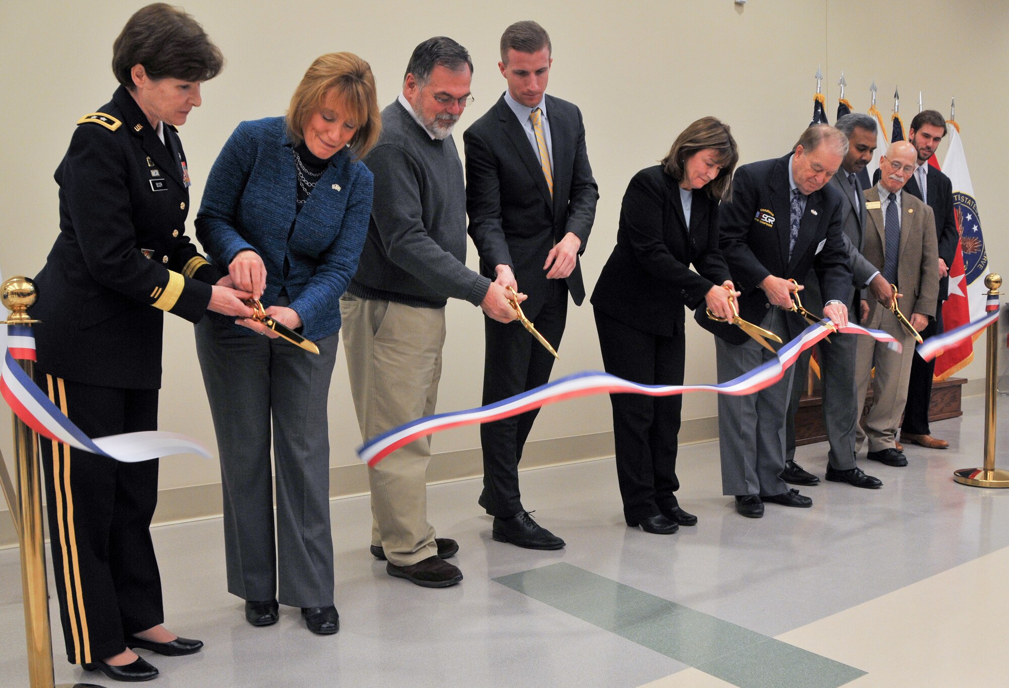 From left, Maj. Gen. Margaret W. Boor, commanding general of the Army Reserve's 99th Regional Support Command, New Hampshire Governor Maggie Hassan and other distinguished guests cut the ribbon during the Dec. 13, 2014, grand opening and memorialization ceremony for the 1st Lt. Paul A. Doble Army Reserve Center in Portsmouth, New Hampshire. The new facility is named for Doble, who served with the Army's 180th Infantry Regiment during World War II and was killed in action in France Sept. 25, 1944, earning a Purple Heart and Silver Star. (U.S. Army photo by Staff Sgt. Shawn Morris/Released)