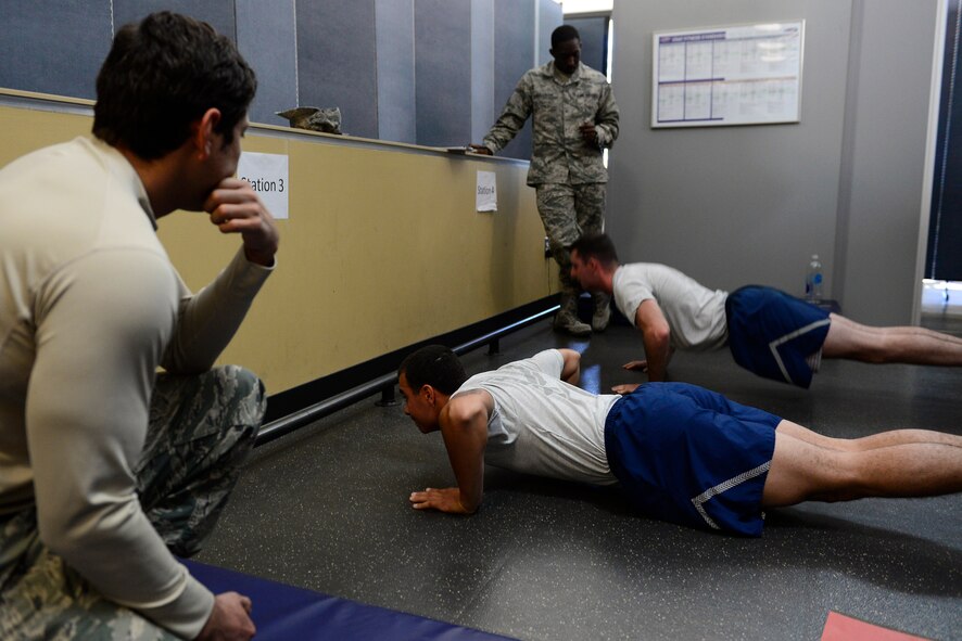 U.S. Air Force Airmen perform push-ups during a physical ability and stamina test at Shaw Air Force Base, S.C., Dec. 10, 2014. In order to pass, the Airmen had to continuously perform the specified physical action for the duration of the two minutes given without stopping. (U.S. Air Force photo by Airman 1st Class Diana M. Cossaboom/Released)
