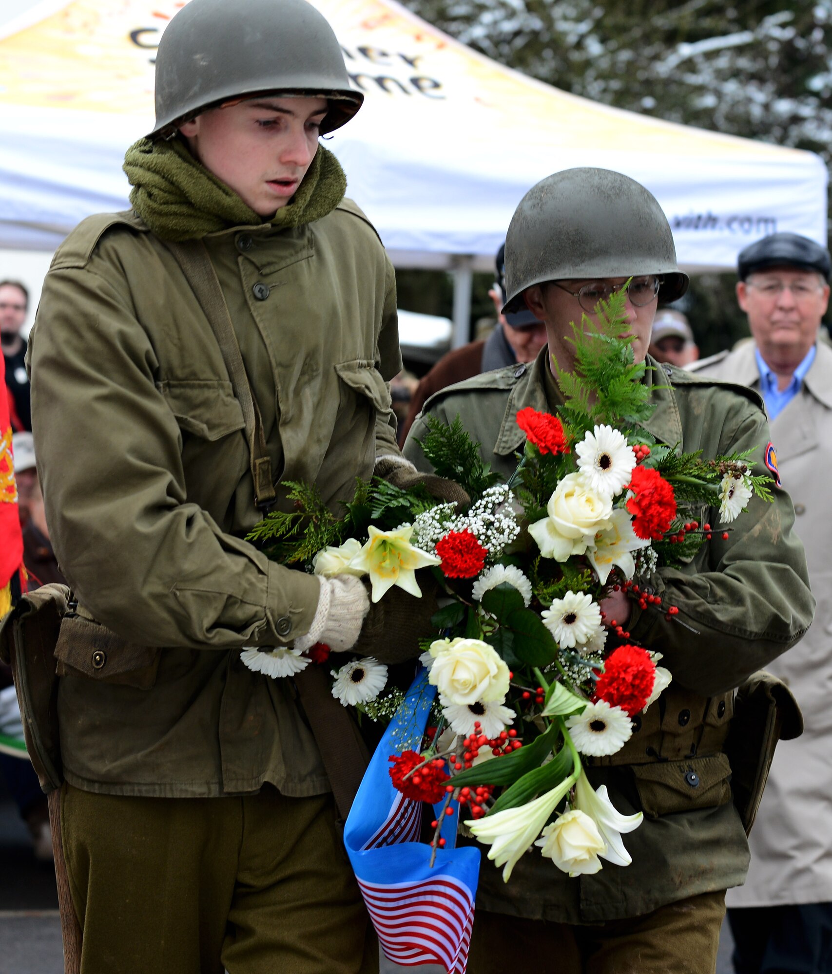 Two Battle of the Bulge reenactors lay a wreath at the U.S. Army 106th Infantry Division monument during a memorial ceremony at St. Vith, Belgium, Dec. 14, 2014. Multiple organizations presented wreaths during the ceremony. (U.S. Air Force photo by Airman 1st Class Luke Kitterman/Released) 