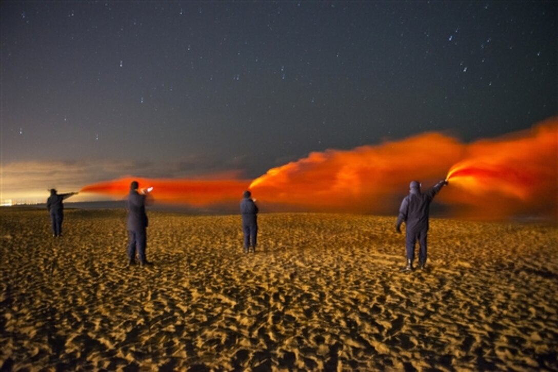 Coast Guard members conduct flare training on Plum Island, Mass., Dec. 15, 2014. The Coast Guardsmen are assigned to the Coast Guard Sector Boston, Coast Guard Station Merrimack River and the First Coast Guard District.  