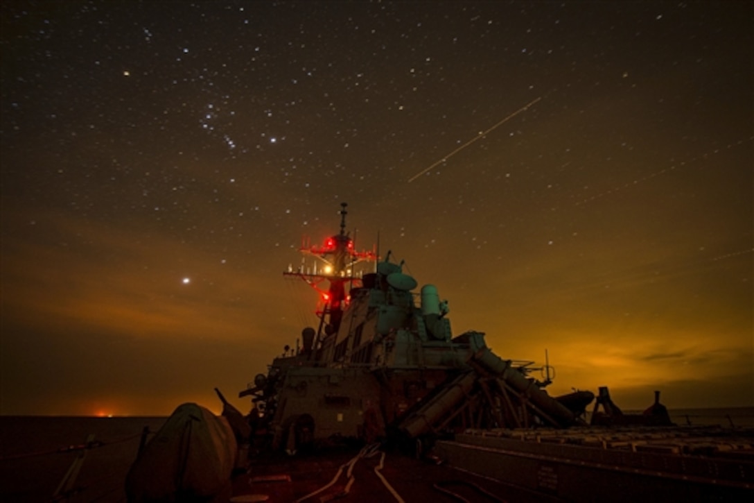 The guided-missile destroyer USS Mitscher lights up its mast during night-delayed landing qualifications with Helicopter Sea Combat Squadron 26 in the U.S. 5th Fleet area of responsibility, Dec 15, 2014.  