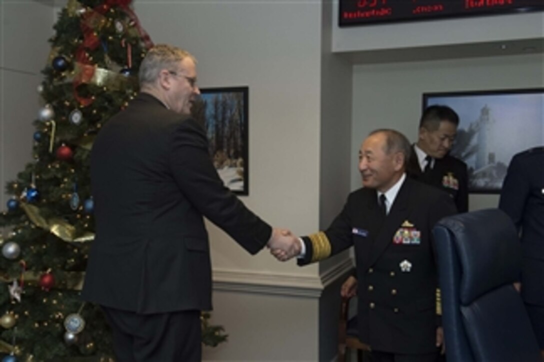 U.S. Deputy Defense Secretary Bob Work greets Adm. Katsutoshi Kawano, chief of the Japanese Self-Defense Forces, as he arrives at the Pentagon, Dec. 18, 2014, to discuss matters of mutual importance.