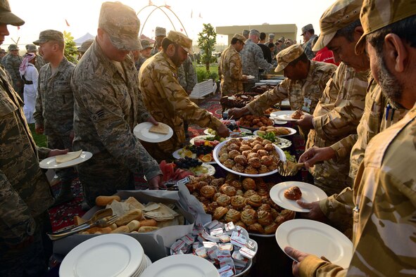 The Qatari military invited U.S. servicemembers deployed to Al Udeid Air Base, Qatar, to celebrate Qatar National Day, over breakfast, on December 18, 2014. The annual holiday is an occasion for Qataris to commemorate their national identity and history, and allows them to remember how their national unity was achieved.  This year’s Qatar National Day celebration included a parade involving all branches of the Qatari military, police, and schools. The parade featured massive fire work displays, military aircraft flyovers, and many other demonstrations of national unity.  Qatar is a key and enduring regional partner of the United States.  (photo by Master Sgt. Kerry Jackson) 